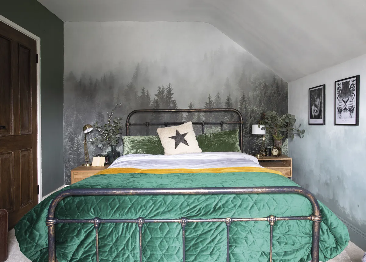 The mural is from a Californian company called Rocky Mountains Decal. Eniko created the ombré walls using Green Smoke estate emulsion by Farrow & Ball. The velvet pillows are from H&M, and the fluffy yellow throw and emerald quilt are from The Conran Shop. Eniko bought the vintage-style metal bed on Amazon. The Wayfair bedside tables are styled with lamps from Laura Ashley