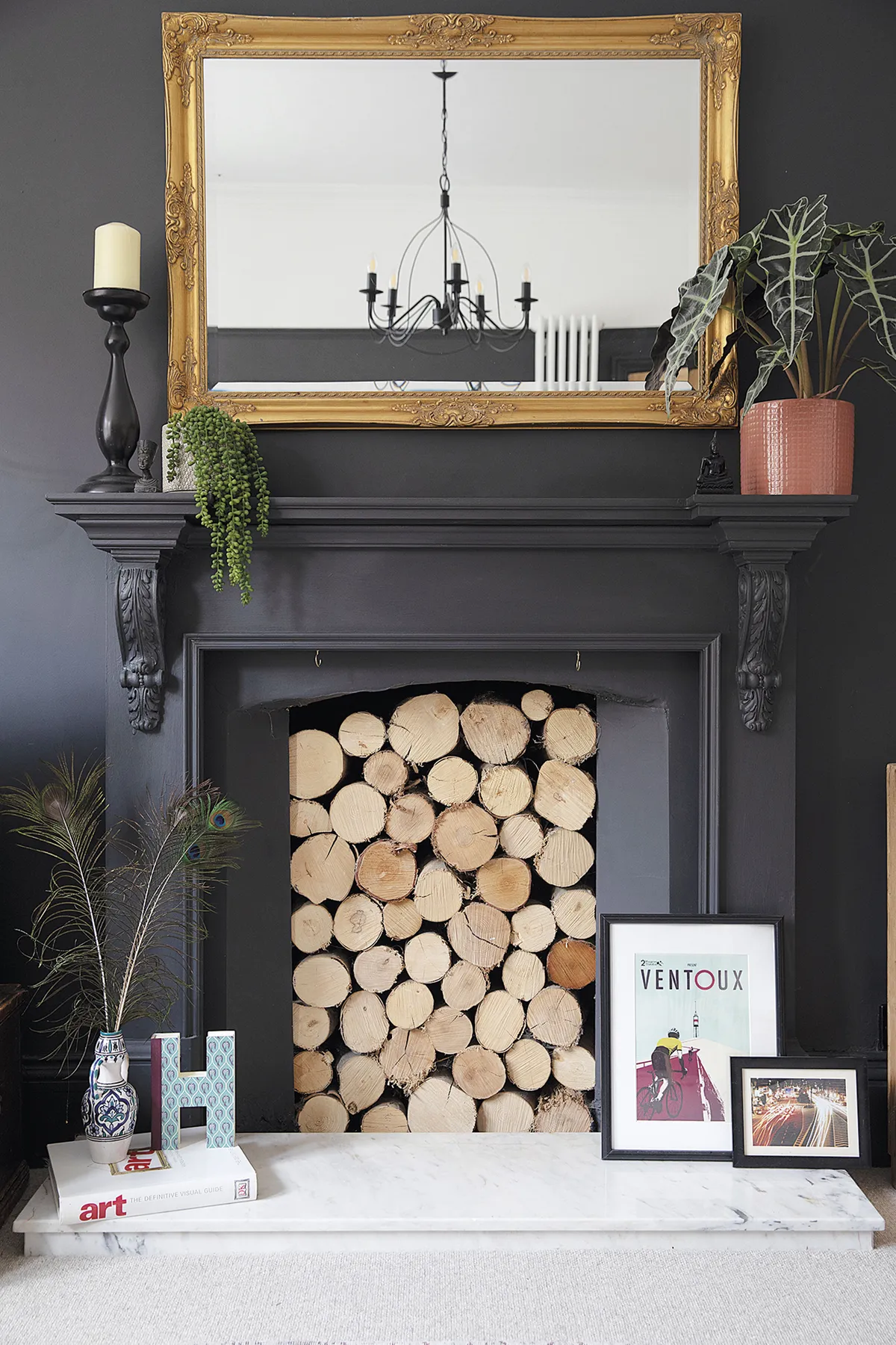 ‘We broke the original Victorian fireplace trying to remove the tiles, so we replaced it with a £50 marble hearth and oak surround from Facebook Marketplace,’ says Sam