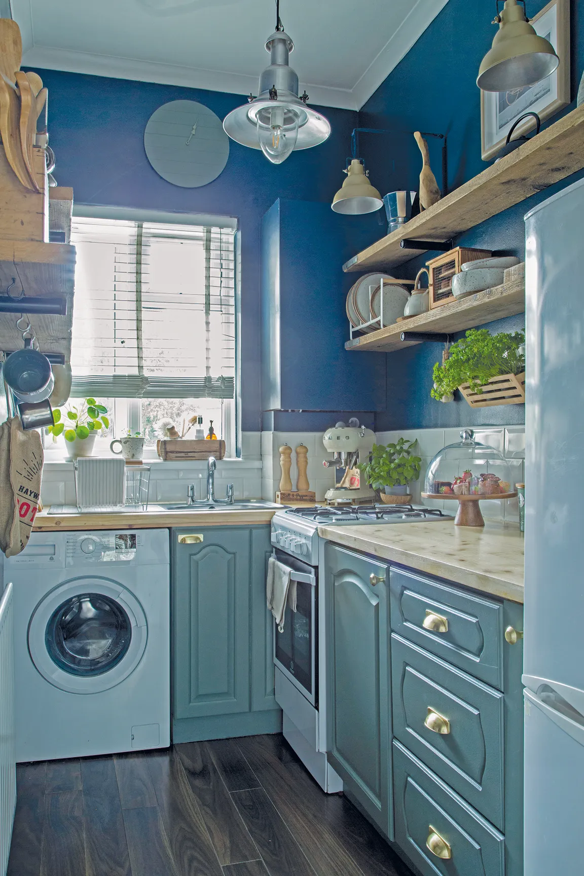 Together, the teal, navy and raw wood tones create a kitchen scheme that feels classic, yet contemporary, as well as rustic and relaxed
