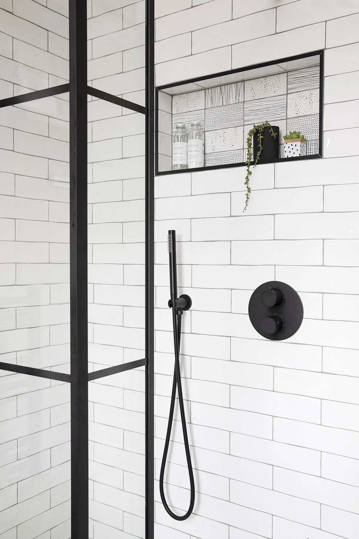 Quirky doodle motif tiles highlight the petite niche shelf, which is now Liz’s favourite part of the bathroom