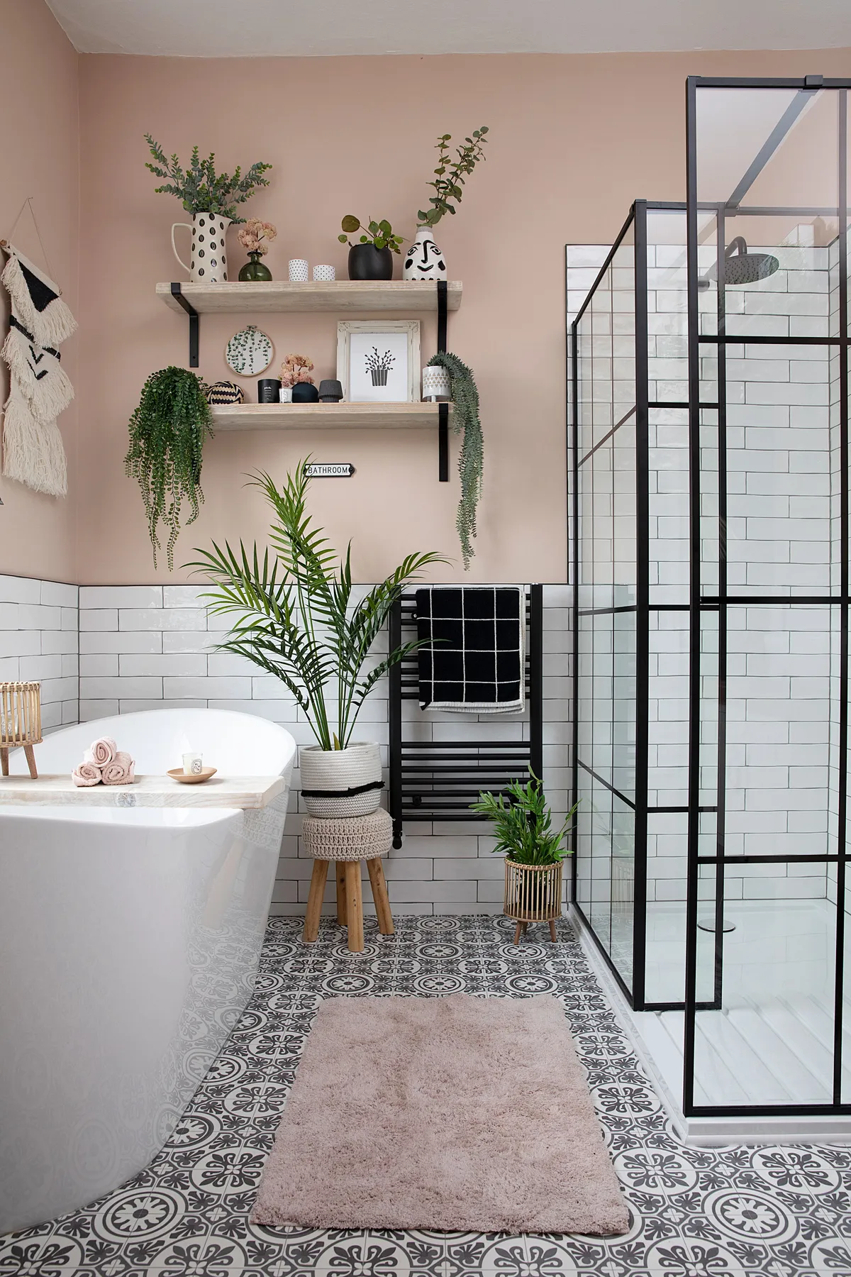 The previous room layout featured both a bath and cramped shower along the back wall with partition in-between. Moving the bath under the window has unlocked the space’s potential