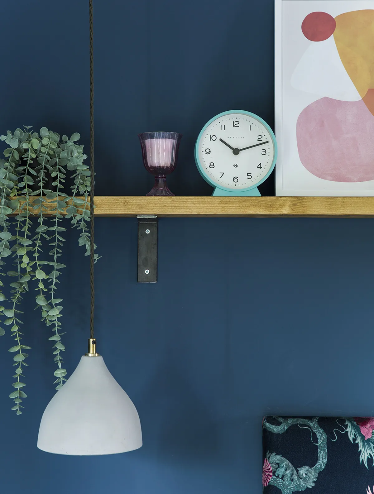 Recycled scaffold wood is used to create a striking shelf above the bed to display colourful prints, plants and Becky’s favourite accessories. Hanging ceiling pendants are a stylish option for bedside lighting