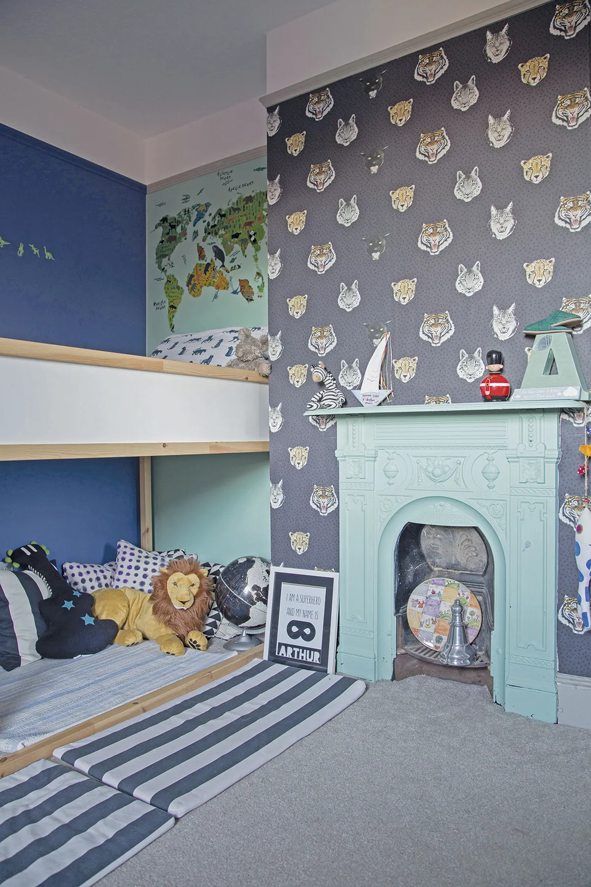 Megan involved Arthur in the design of his bedroom by allowing him to choose the wallpaper. The animal head motifs paired with dark and aqua blue wall paints create a smart, yet fun scheme