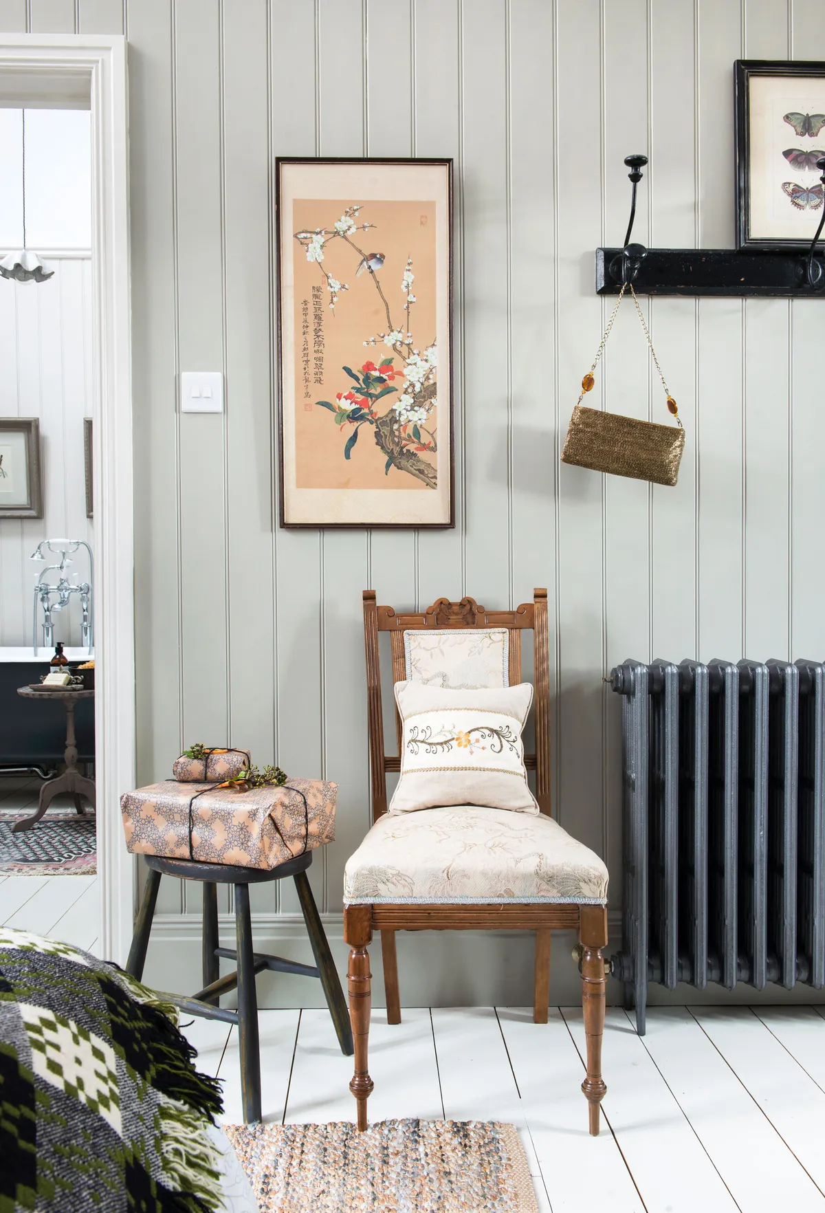 Kay has created continuity between two adjoining spaces by adding panelling in both her bedroom and bathroom, painted in the same colour. She has also carefully curated a selection of vintage pieces for each room for a coherent feel