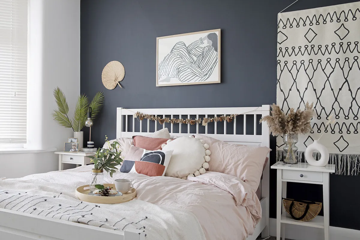 Monochrome artwork, like the wall hanging from La Redoute and print from Alice In Scandiland, work well against the dark walls while a geo cushion from La Redoute adds warmth and pattern. ‘I’m always chopping and changing cushions and wall hangings,’ says Louise