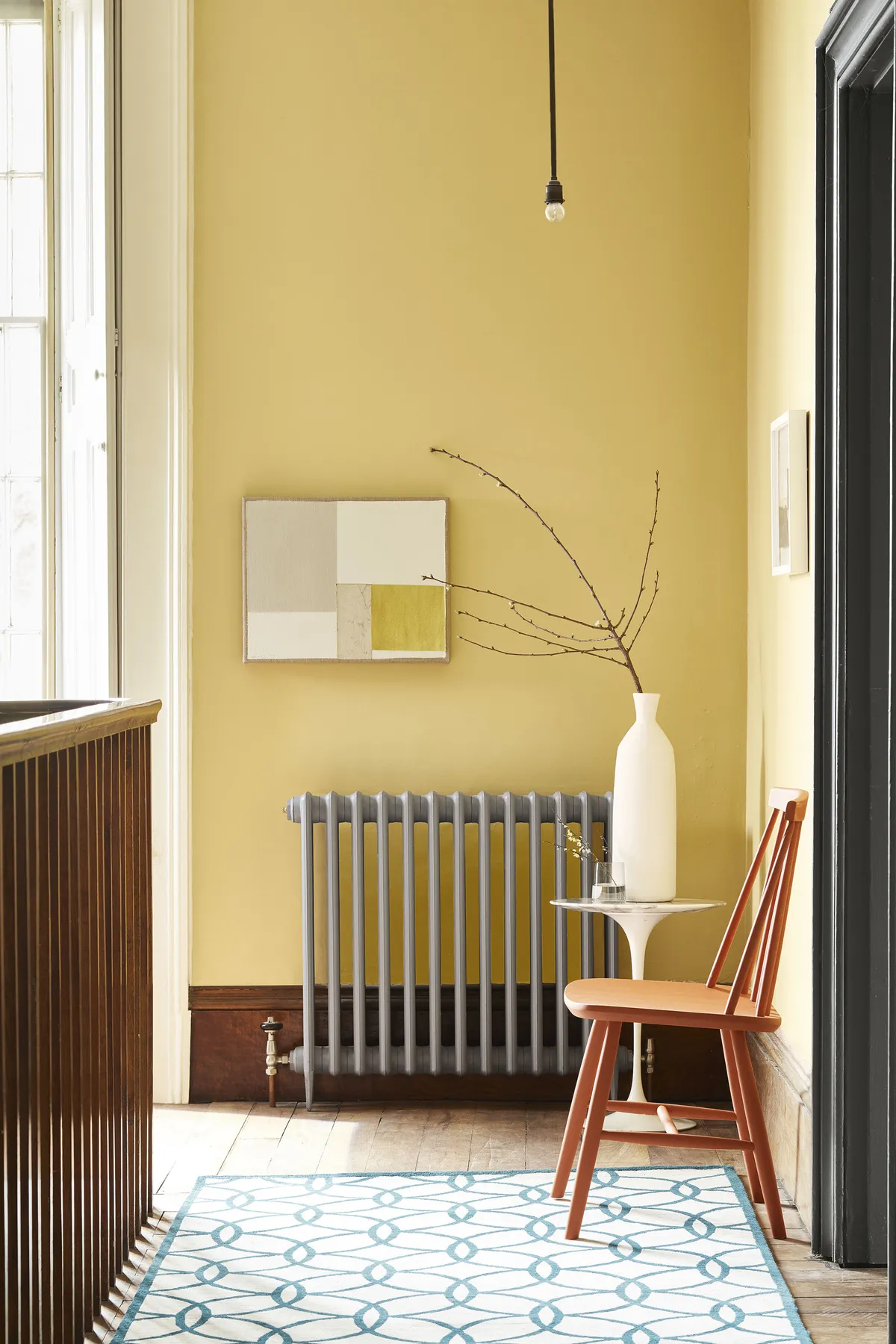 Wall painted in absolute matt emulsion in Light Gold; radiator painted in Urbane Grey, both from £23.50 per litre, Little Greene