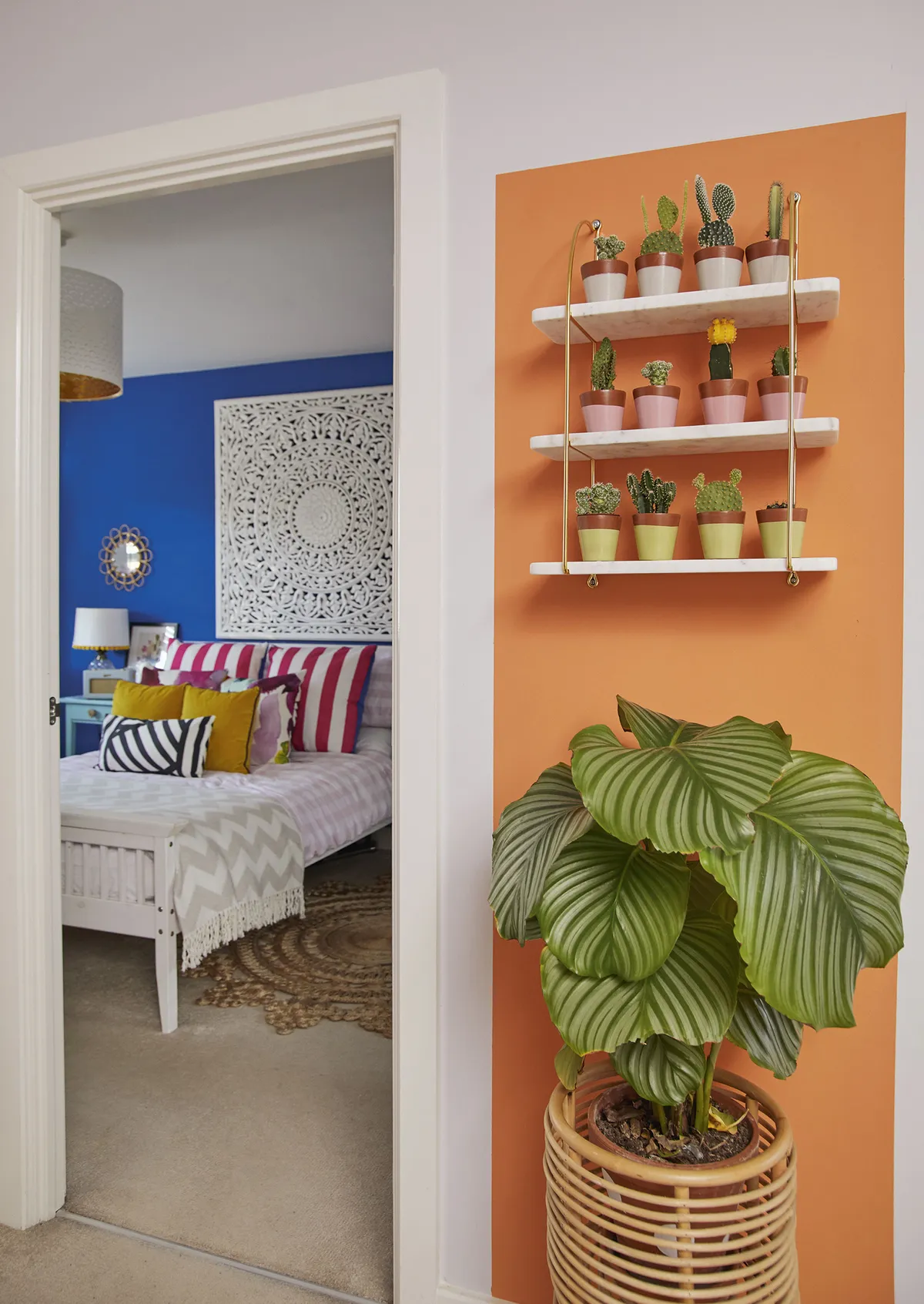 ‘The landing is really dark, so adding this colour block of orange brightens up the space and I love the clash with the blue. The shelves are from La Redoute and the cacti and plants are from a local garden centre – they were so cute that I just went mad and bought them all’