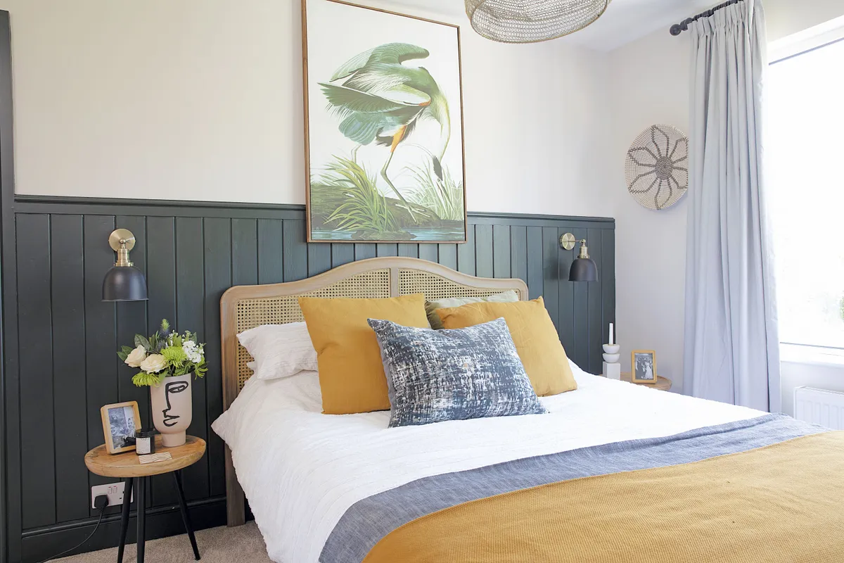 ‘Our joiner made the panelling, which we painted in Studio Green by Farrow & Ball,’ says Laura. ‘The wall lights from Iconic Lights work really well against it, and I picked two £30 side tables from Wayfair to keep costs down. I love the face vase from H&M Home too’