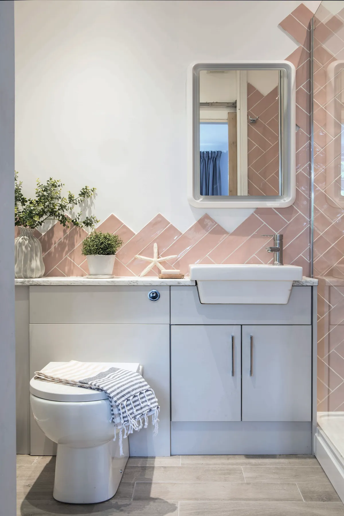 In the bathroom, blush pink tiles, from CDT Tiles, laid in a zigzag pattern draw the eye and bring a splash of colour to Joanne’s neutral palette.