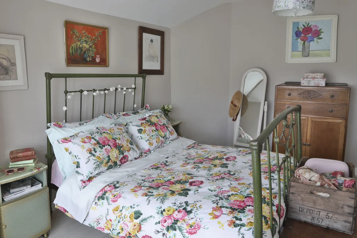 To create a homely feel, Hildah’s combined vintage furniture – the metal bed, wardrobe, tallboy and Lloyd Loom-style bedside tables – with a few high street finds, including a floral duvet cover from Joules and a bright flower print from Next