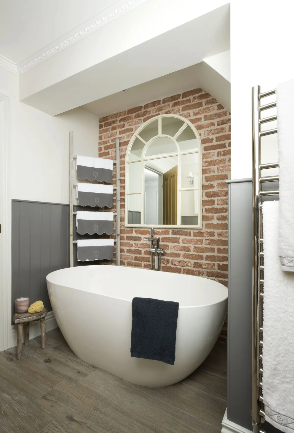 Lisa paired a contemporary bath with a free-standing tap to create a boutique hotel feel. The feature brickwork wall is made from brick-slip tiles – these thin slivers of real brick are a fast, stylish alternative to the real thing