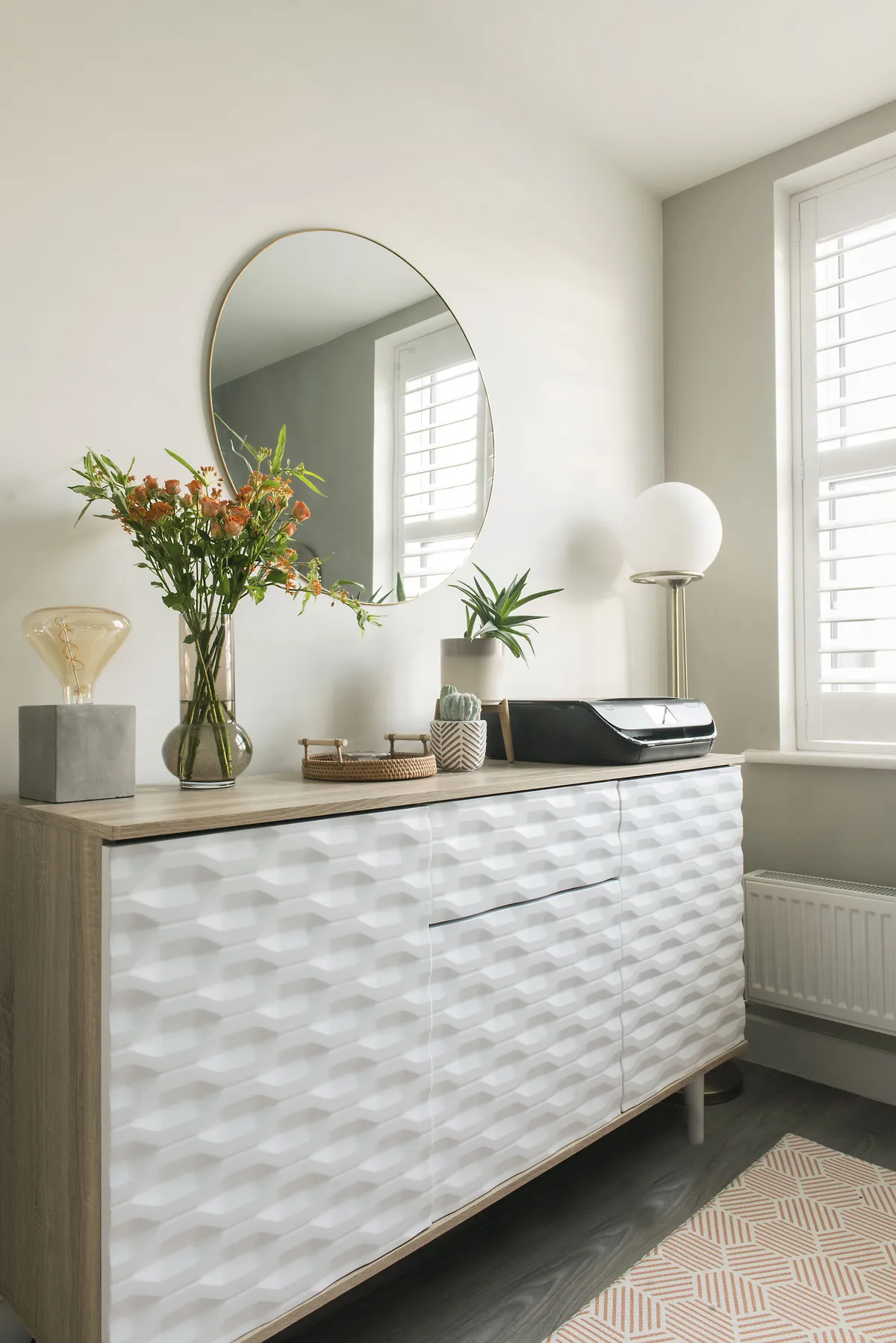 Lydia increased storage with a smart sideboard opposite the main work area. The cupboards, which have a similar, textured finish to the wall units, can take A4 files, and the neat centre drawer is perfect for stationery