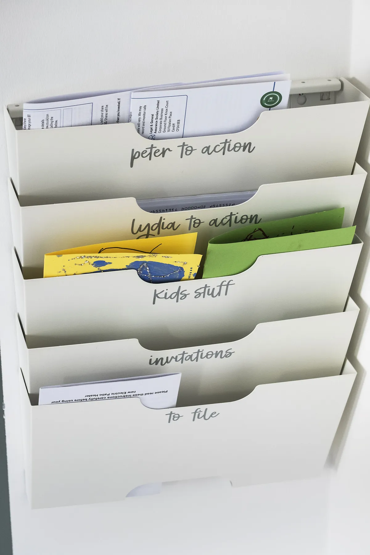 Mounted by the door, so it’s always in sight, a nifty wall-file is handy for keeping track of important paperwork. Lydia added personalised, stick-on labels so things stay well-organised