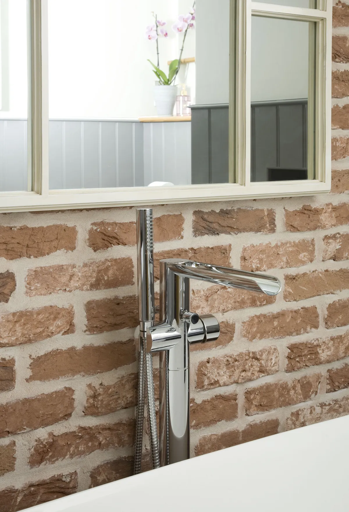 Fashionable taps date quickly, so Lisa stuck to a simple, stainless-steel design for her floor-standing bath filler, which contrasts beautifully with the brick-slip tiled wall