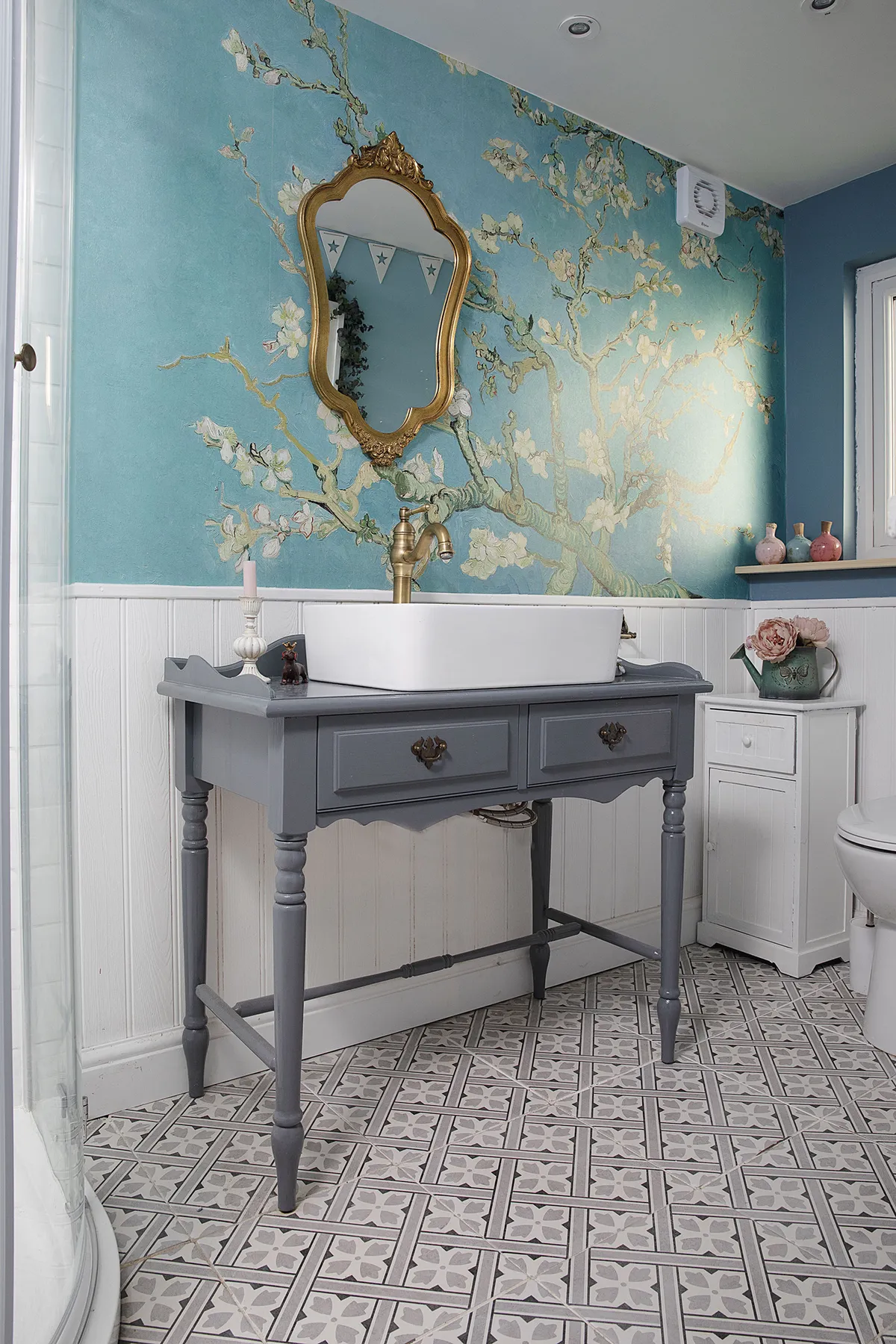 The mural makes a great statement in this small bathroom, adding bold colour and pattern to this small space