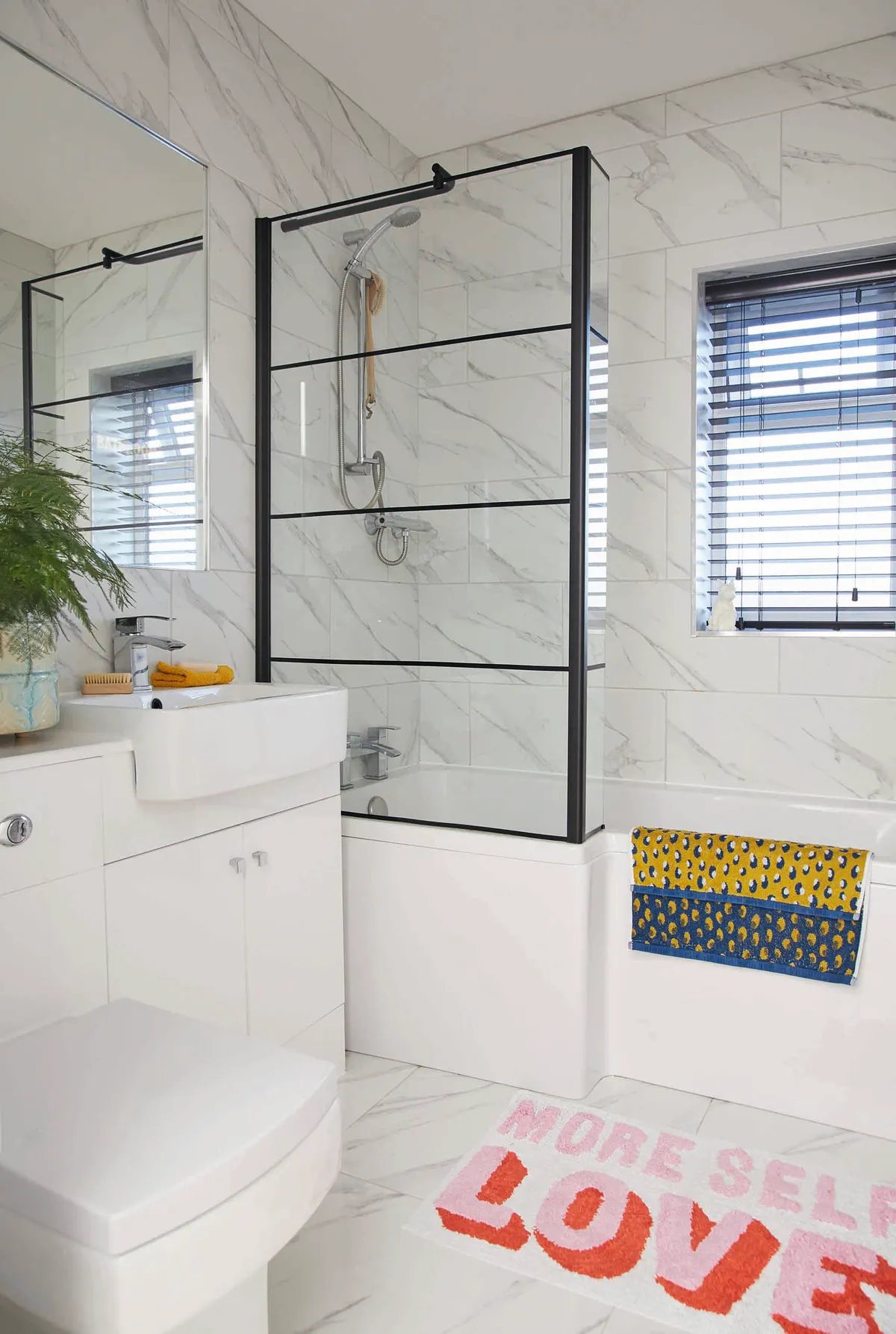 This all-white bathroom isn’t what I would choose, but it’s easy to add a bit of colour using these yellow and blue towels from George Home and the fun bath mat from Urban Outfitters
