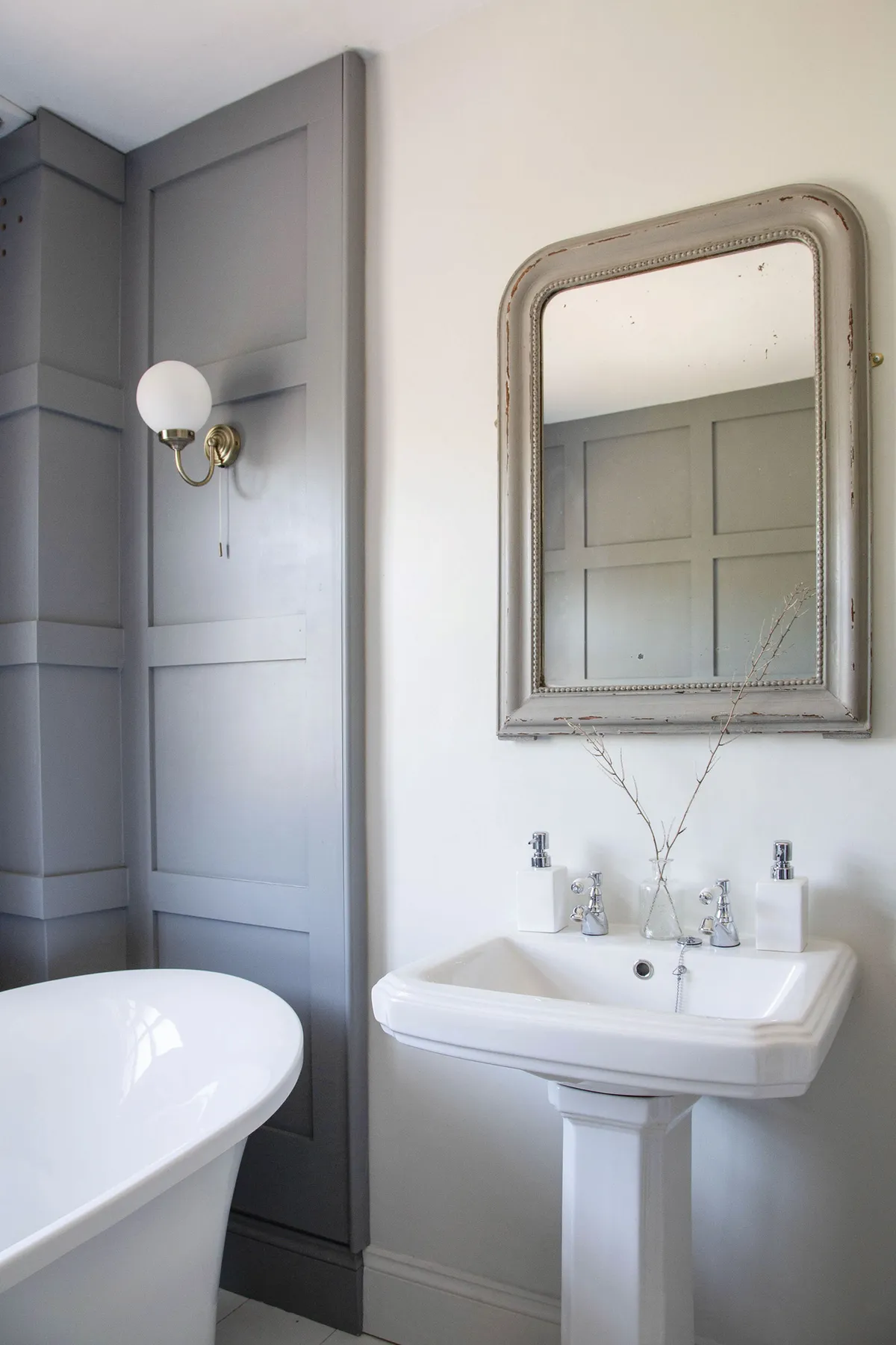 Vicky stays true to the property’s age with traditional fixtures in the bathroom, including a bevelled-edge sink, classic chrome taps and a vintage-look wall light fitting