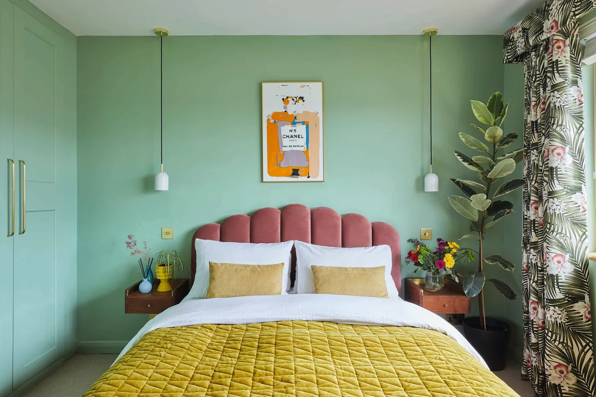 The master bedroom has been painted in Pea Green from Little Greene. Hanging wall lights from MADE.com and floating bedside tables are stylish space savers
