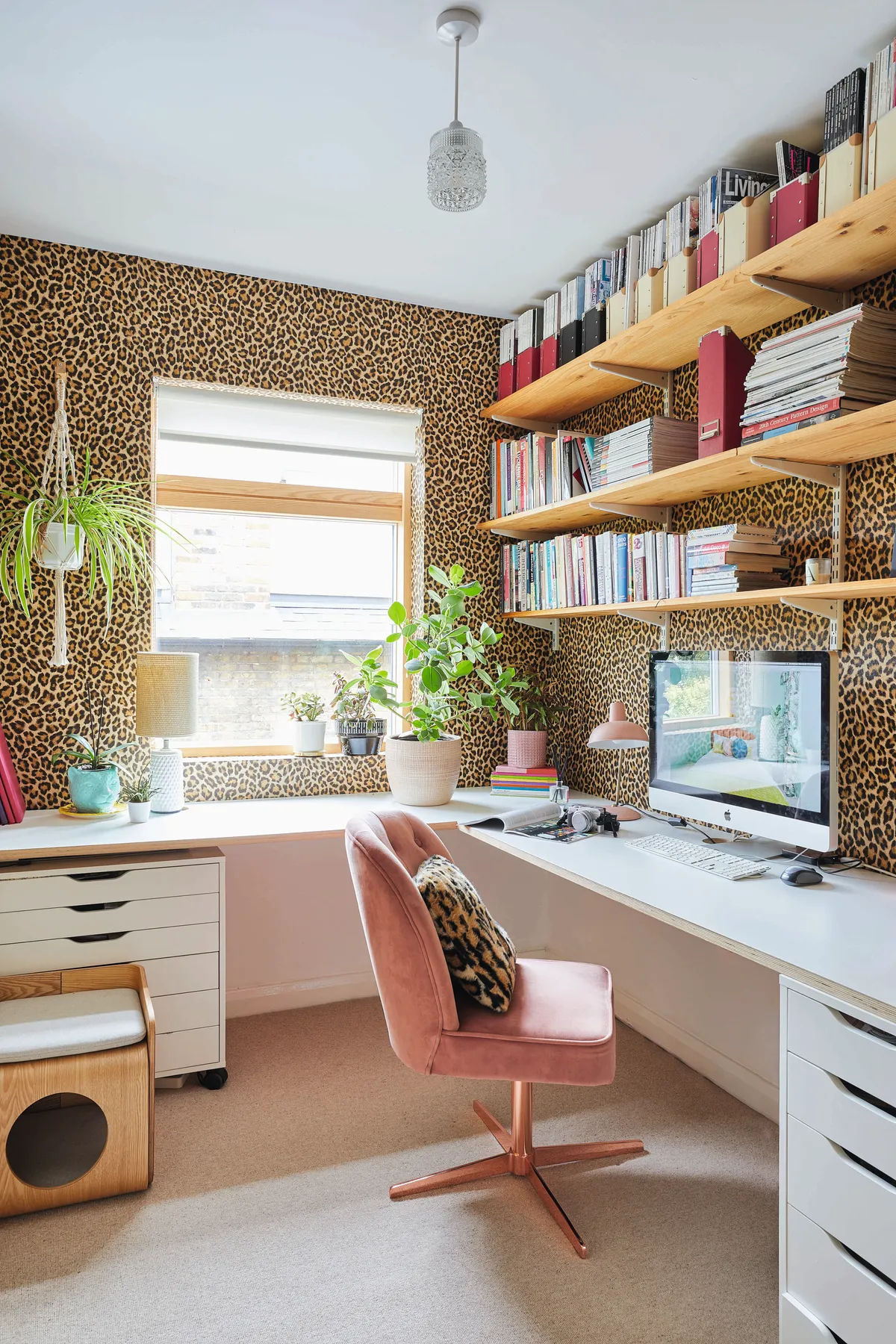‘In lockdown this room has been a godsend,’ Bo says. Leopard-print wallpaper from Albany gives the room a fun, bold look with the pink swivel chair from Cult Furniture topping off the glam style. A made-to-measure desk and shelving provides Bo with plenty of work and storage space