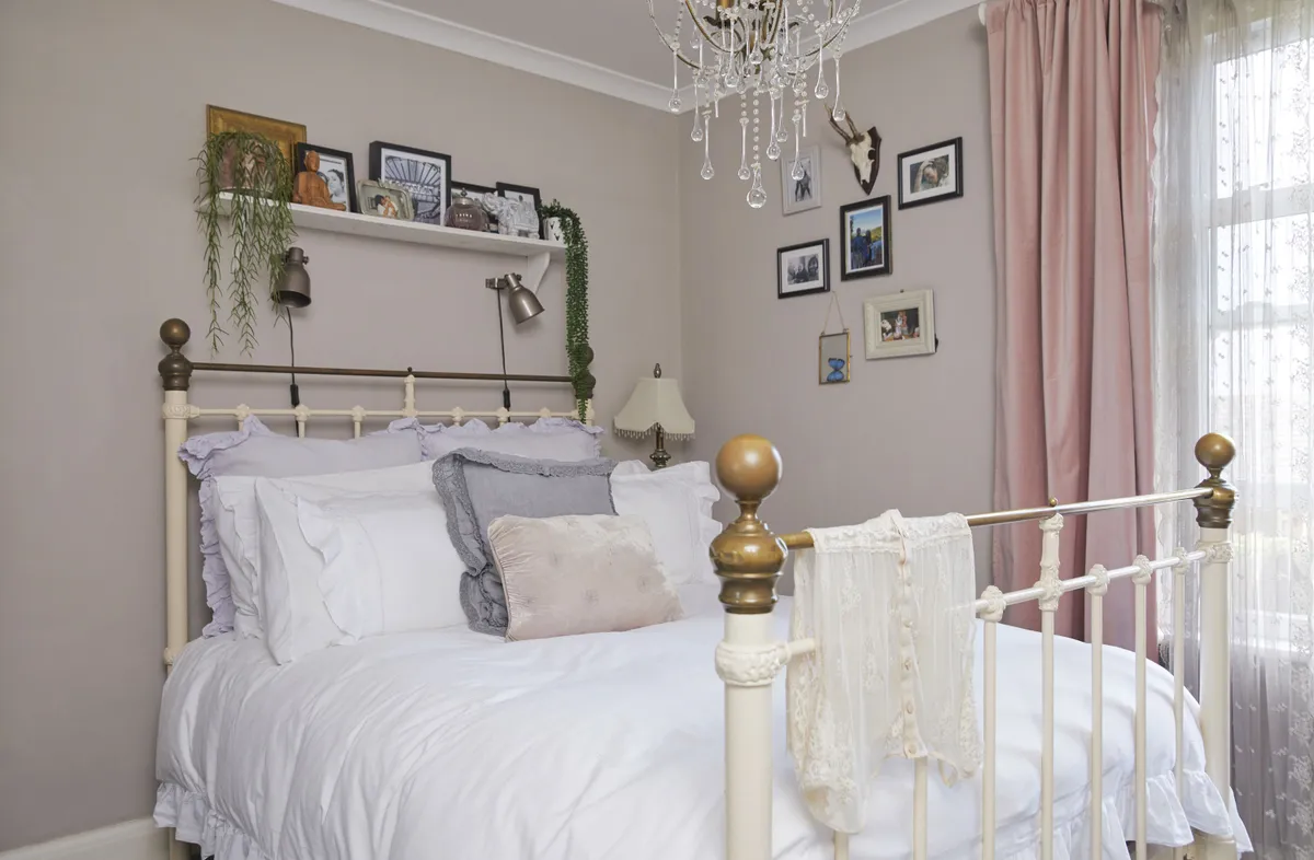 ‘I love the frills on this bedding from Laura Ashley, it gives the room a delicate feel that I’ve balanced with industrial-style wall lights. My gallery wall is mainly made up of my fave family photos’