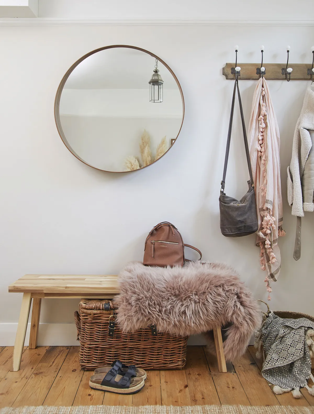 ‘I bought the IKEA mirror to go above the fireplace, but I leaned it against this wall while moving some things about, and it looked good here so it stayed. This is often quite a messy spot, so the basket keeps shoes tidy’