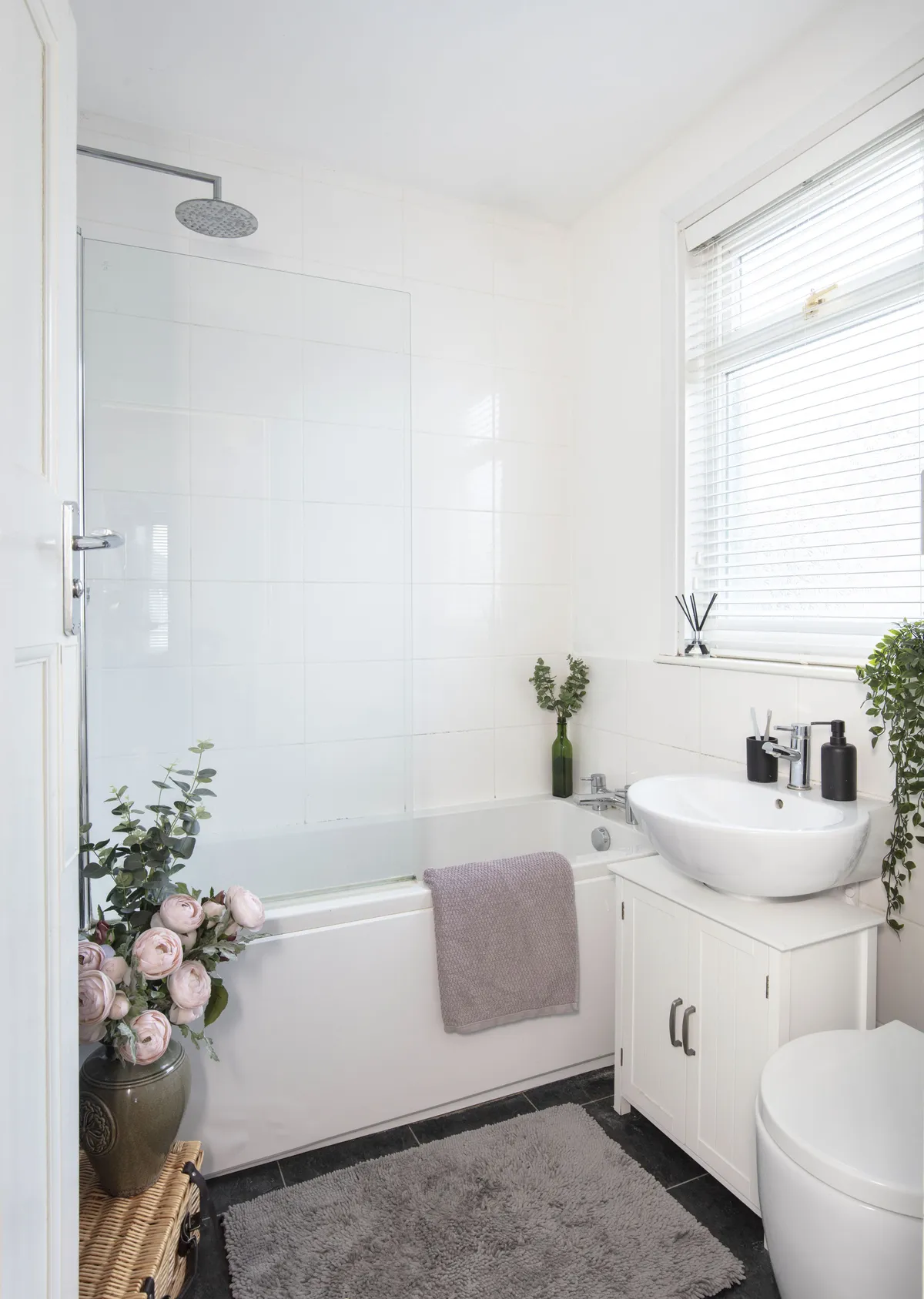 The couple plan to replace the bathroom with a free-standing bath and new tiling, but for now they’ve added pretty lilac touches to the current neutral space