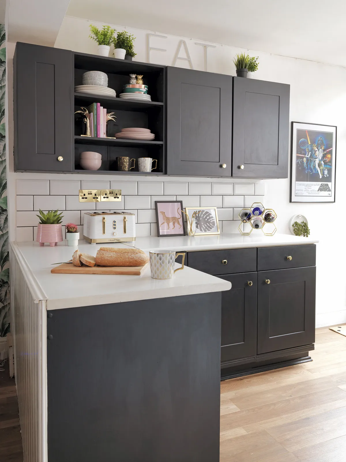 Black painted cabinets in the kitchen have been given a more feminine flourish with pale pink crockery and accessories. The Star Wars print was Aaron’s choice – ‘it’s quite possibly his favourite part of the house,’ laughs Raya