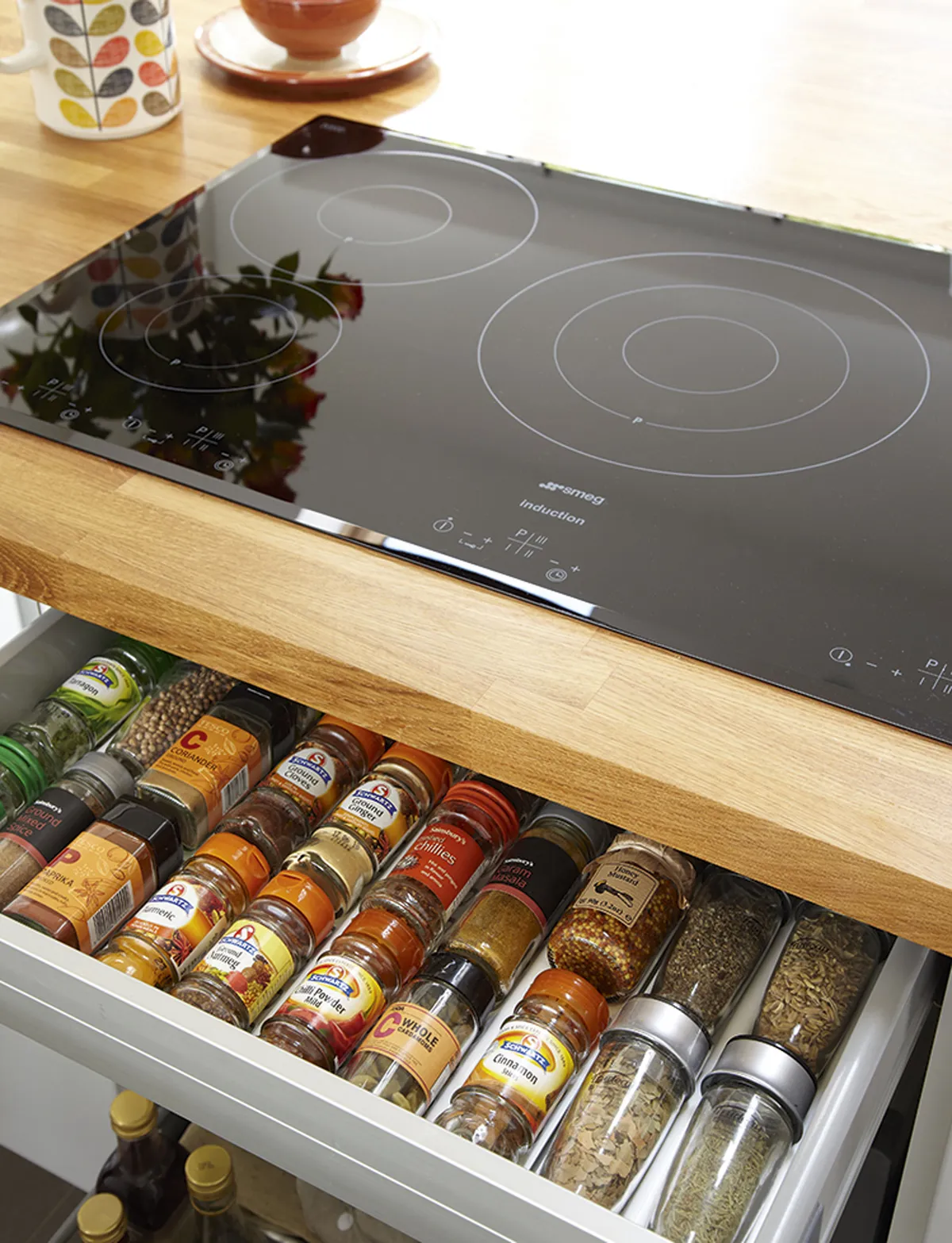 Julie has been clever with space-saving ideas, including installing a hob in the island and a spice drawer underneath