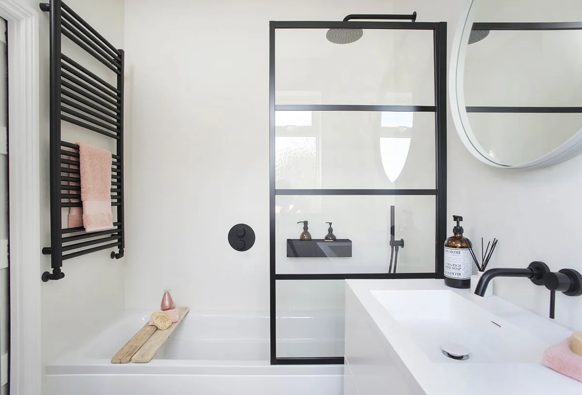 Sina replaced the old bath with a longer one that gives her a roomier tub in a smaller space. The no-frills design lets the smart screen and black fittings be the stand-out features in her design