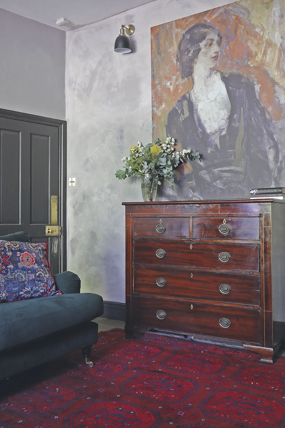 ‘My husband, Trevor, gave this wall a broken plaster effect using different paints. I knew I wanted a strong bold piece here and found this canvas at Surface View. It’s called Lillah McCarthy by Ambrose McEvoy from their National Portrait Gallery collection. The chest of drawers was inherited from Trevor’s mum and works well with the antique Persian rug’