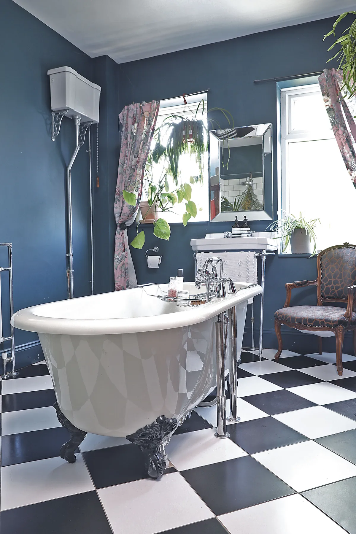 ‘I wanted the bathroom to look very Victorian with the high cistern toilet, monochrome flooring and vintage curtains. We chose Hague Blue by Farrow & Ball for the walls as the room’s so big and light, it can take it’