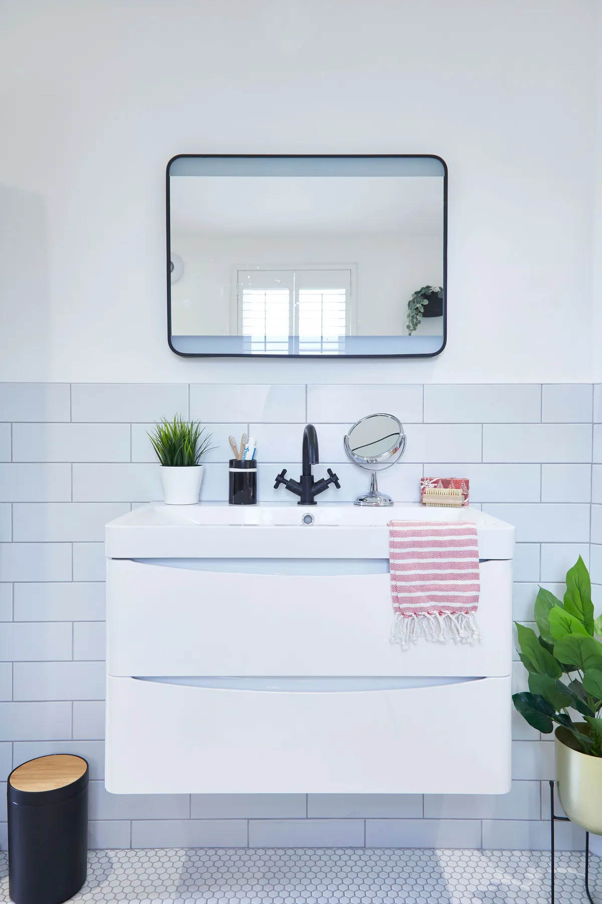 For a busy family bathroom, choose a sink as large as your space will allow. Emily’s floating wall unit has built-in drawers for a space-saving clutter solution