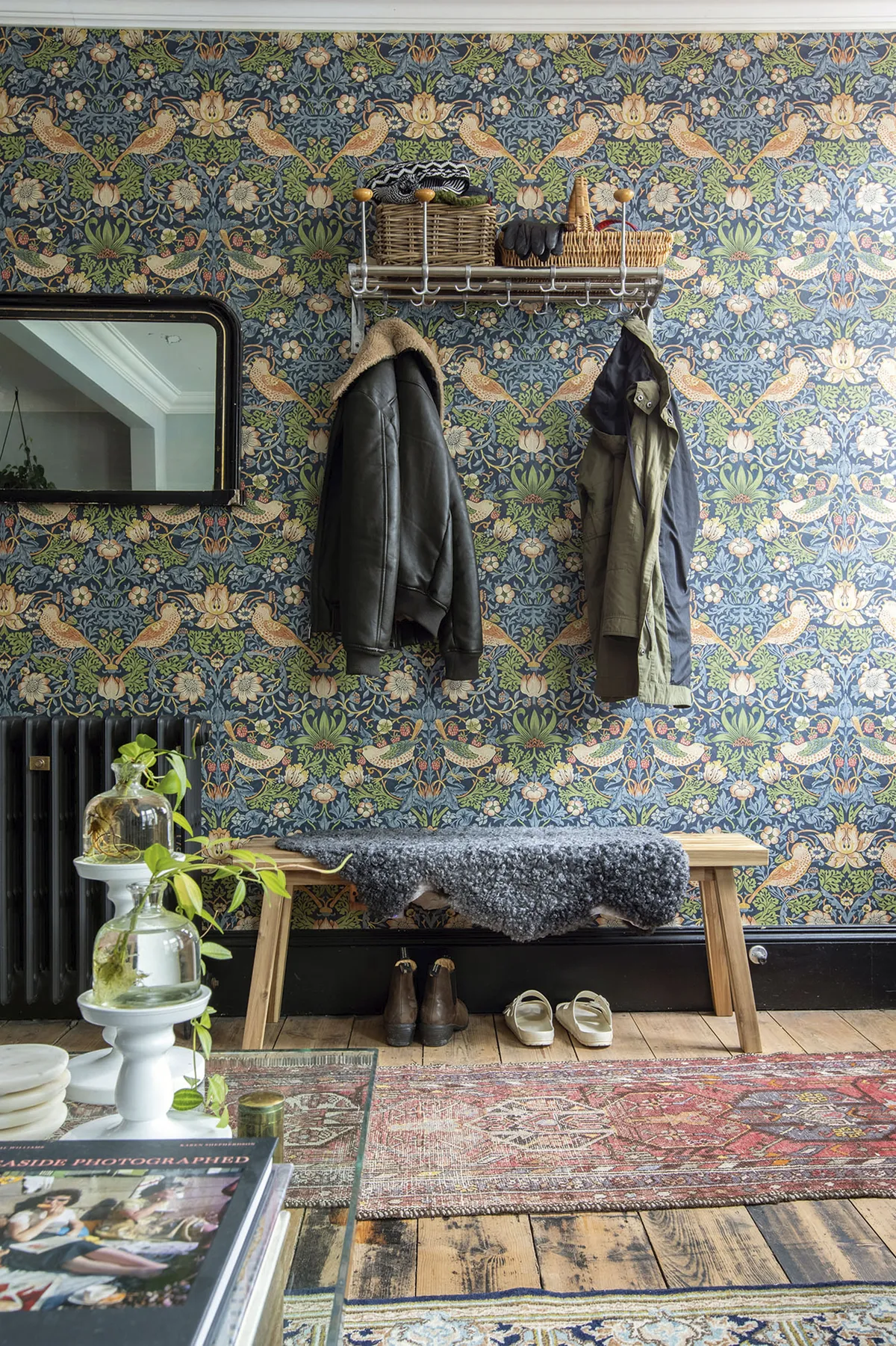 In the hallway, William Morris’s Strawberry Thief wallpaper sets the tone for a bold, design-led house. A vintage coat stand from Johan’s parents is complemented by an IKEA bench and Swedish sheepskin