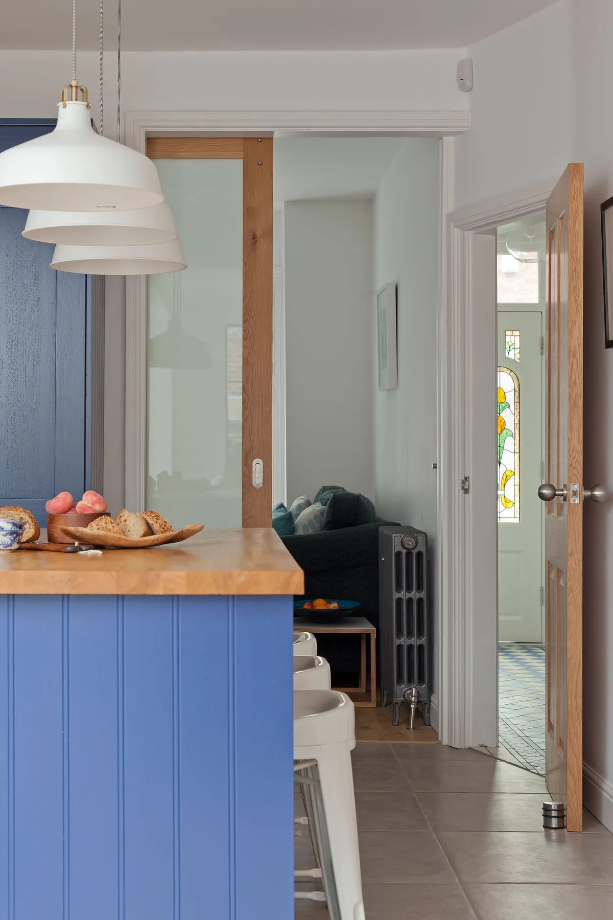 Deep blue units add a dramatic dash of colour against the dazzling white walls