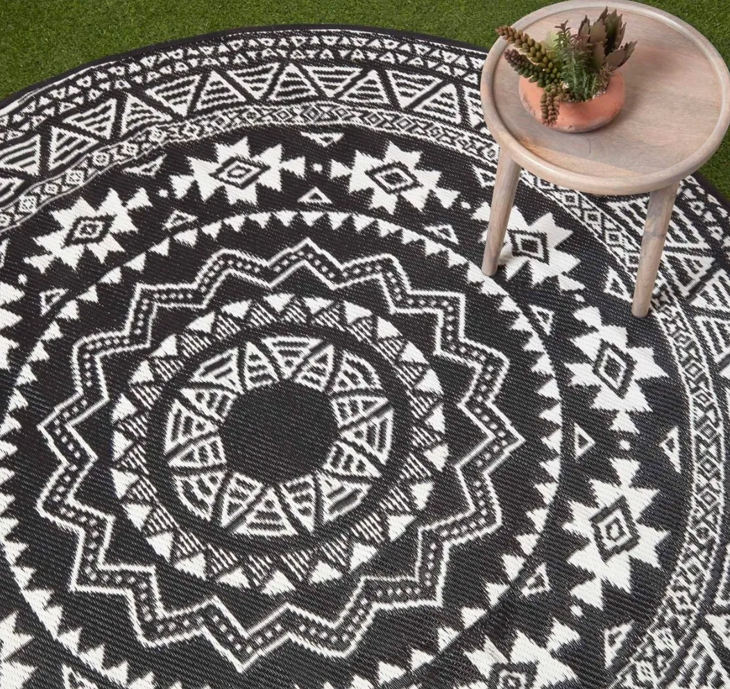 https://www.homescapesonline.com/black-and-white-motif-design-circular-reversible-outdoor-rug.html