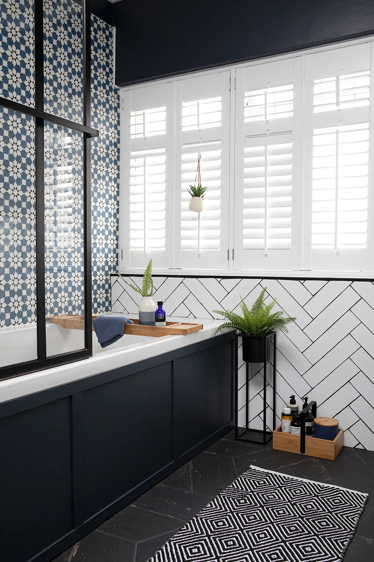 Good idea! Use a hue from patterned tiles throughout for a co-ordinated look, as Claire has with the black details in hers
