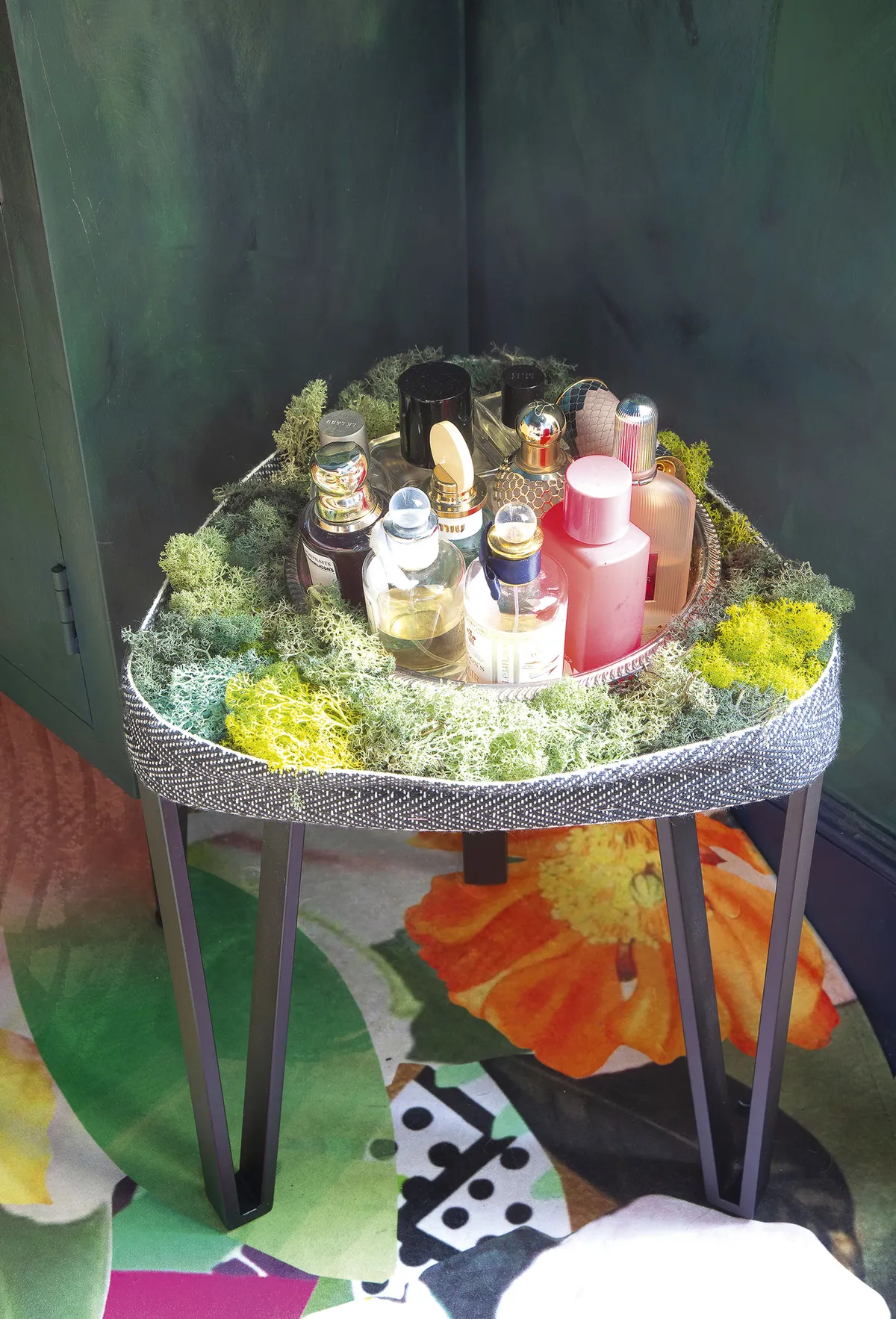 Dodo has created a fun display with her perfume bottles, surrounding the collection with moss that enthusiasts use on train sets