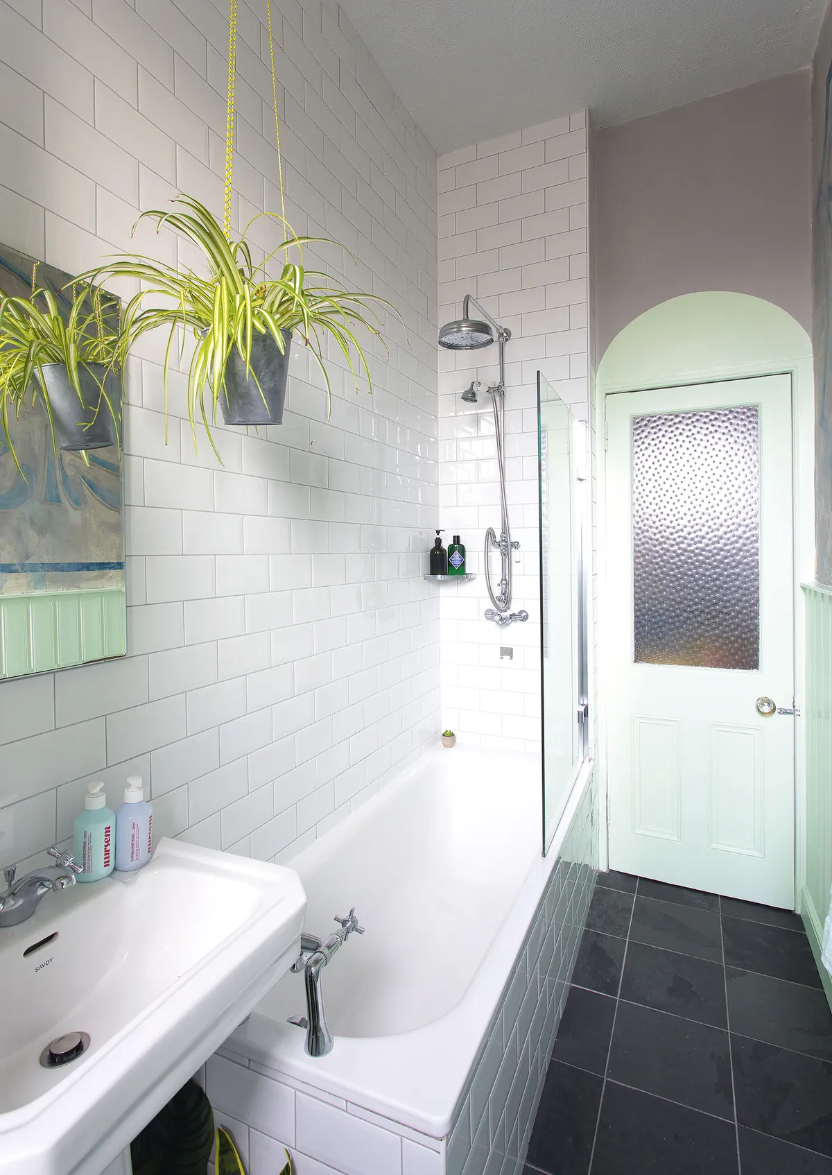 ‘To add colour to the all-white bathroom suite, I painted the panelling in Mint Gel by Leyland. I also painted the door frame the same spearmint shade, painting an archway around it for added interest’