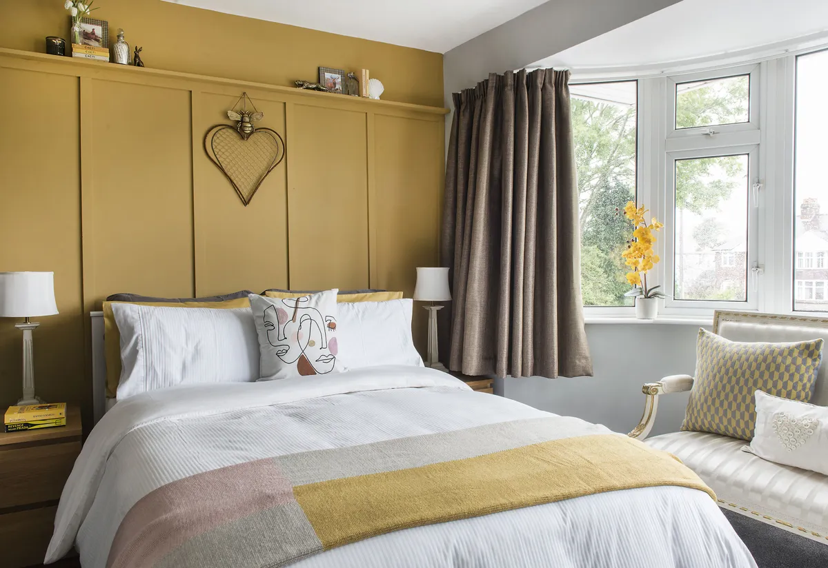 Sarah used a warm palette for her inviting guest bedroom, with panel detailing created by Colin and painted in India Yellow by Farrow & Ball. She’s kept the accessories simple, with co-ordinating bedding and a throw and an abstract cushion from Dunelm