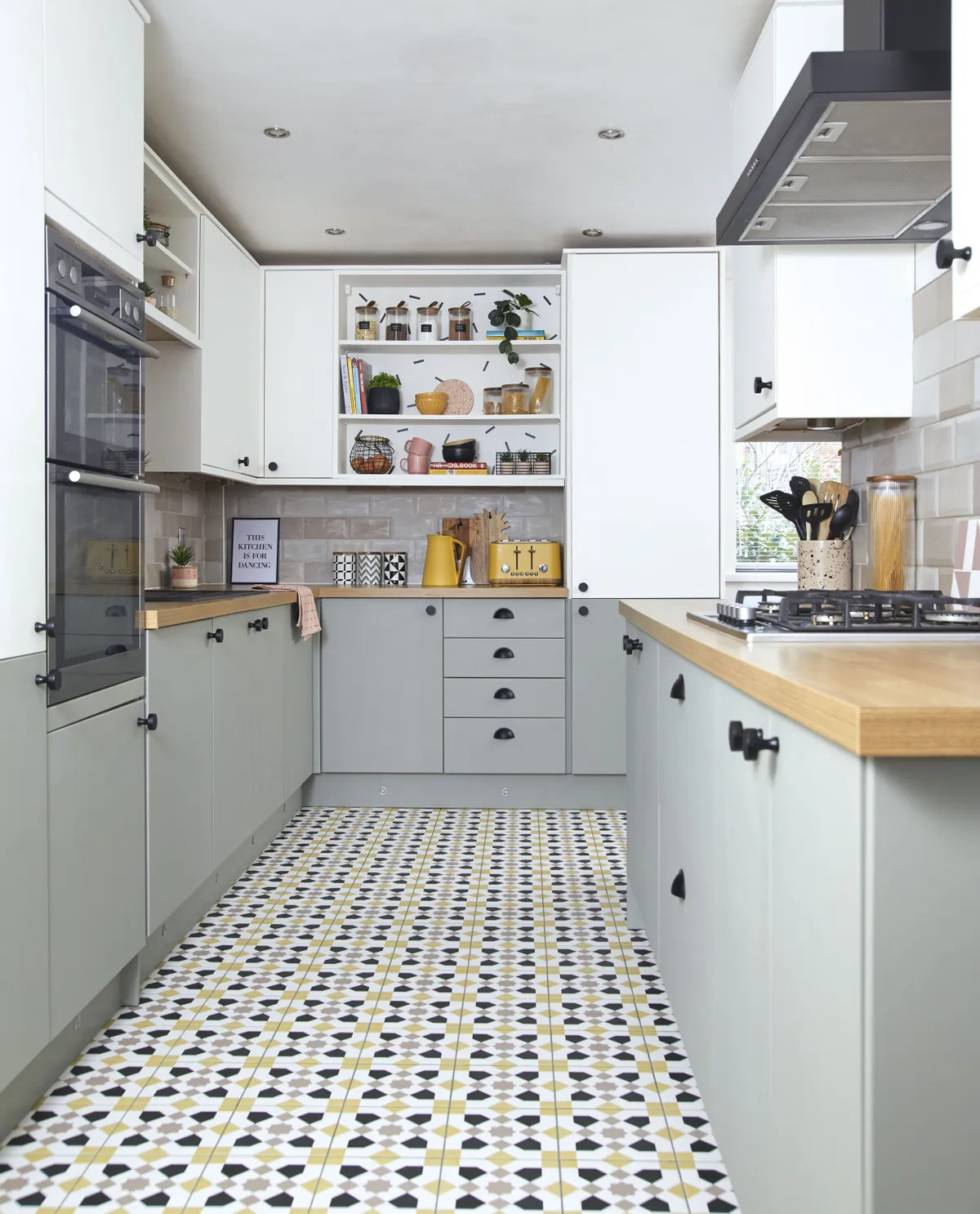 ‘This is exactly the same kitchen with the same units, worktops and wall tiles as when we first moved in, but we painted the low doors in Pigeon and the top in Wimborne White by Farrow & Ball, using a colour match service to save money, and then we replaced the handles and now I really like it!’