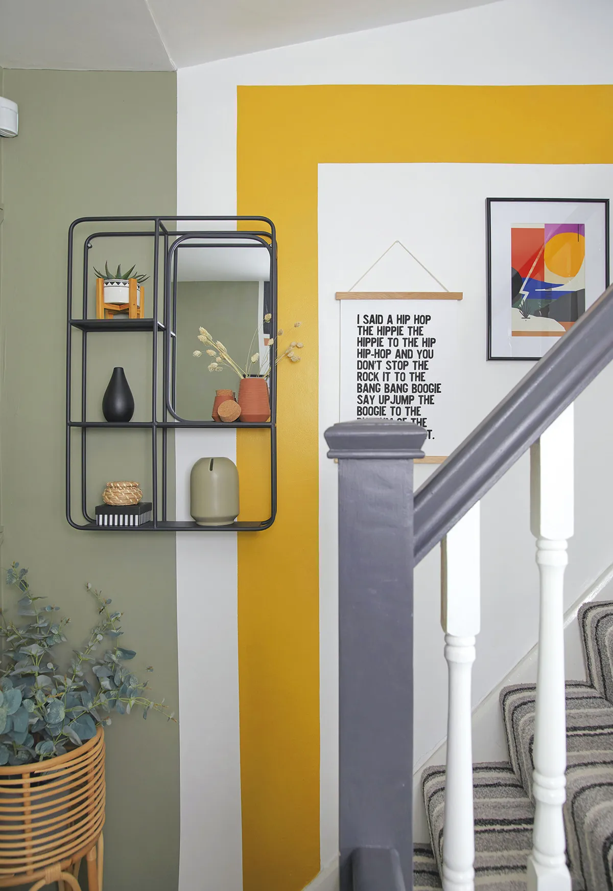 ‘The colours in the hallway, a bright yellow complemented by a soft green, are a nod to the main colours running through the rest of the house, and using them here brings the scheme together’
