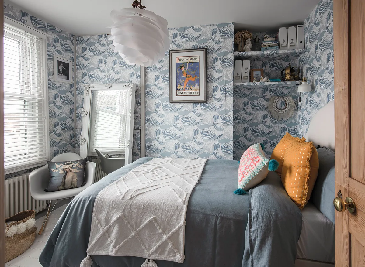 The guest bedroom is decorated in Great Waves wallpaper by Cole & Son, which is now discontinued. ‘I’ll never take it down as this wallpaper is irreplaceable,’ she says. ‘It’s always sunny in here, so it’s a happy room for guests to stay in’
