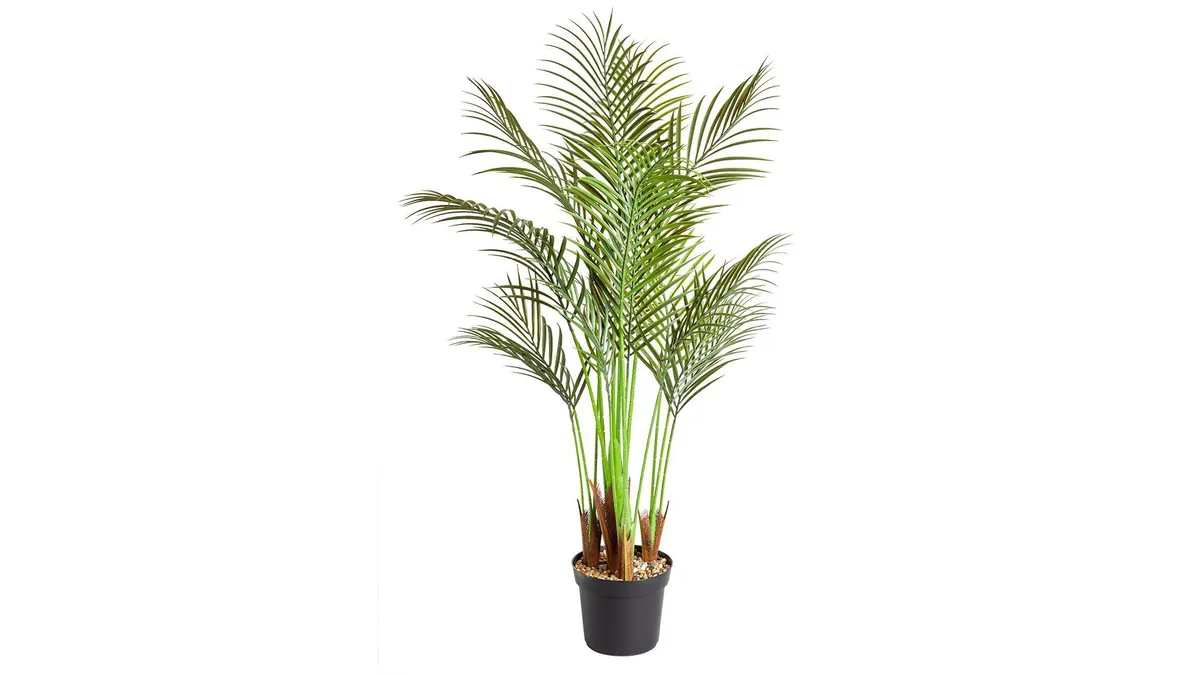 A faux palm tree in a black pot on a white background.