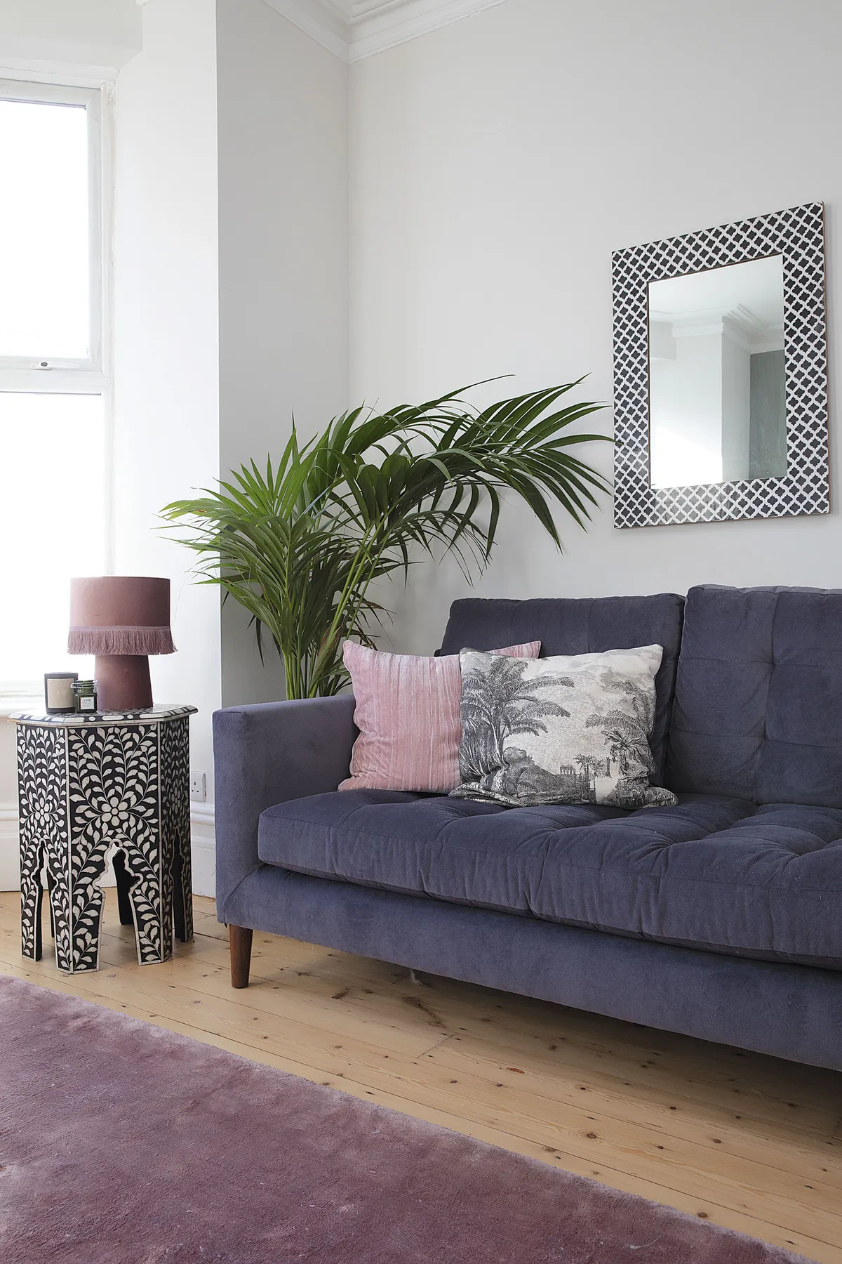 ‘I’ve added monochrome elements to ground the scheme, such as the Swoon side table, HomeSense mirror and cushion from H&M Home. Pink accents, like this HomeSense tassel lamp, are dotted throughout the house’