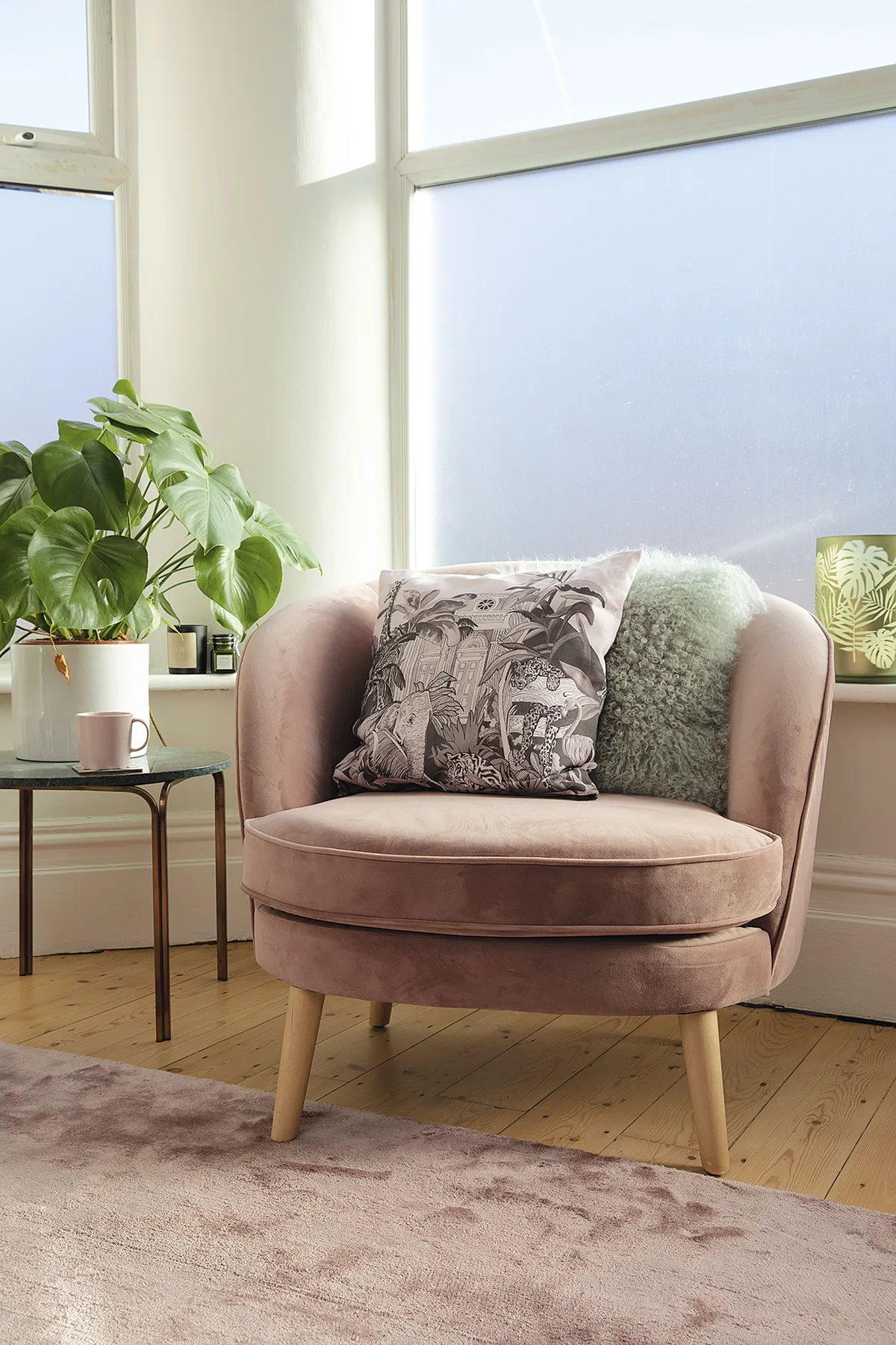 ‘For privacy, we’ve added frosted- effect window adhesive in the living room. It’s the perfect spot for my pink MADE.com chair, and the monochrome cushion from The Wild Kind London’