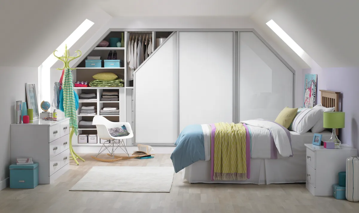 Angled sliding wardrobes combine with co-ordinated interior cabinetry to cope with even the most awkwardly shaped ceilings of a loft bedroom. From £3,500, My Fitted Bedroom