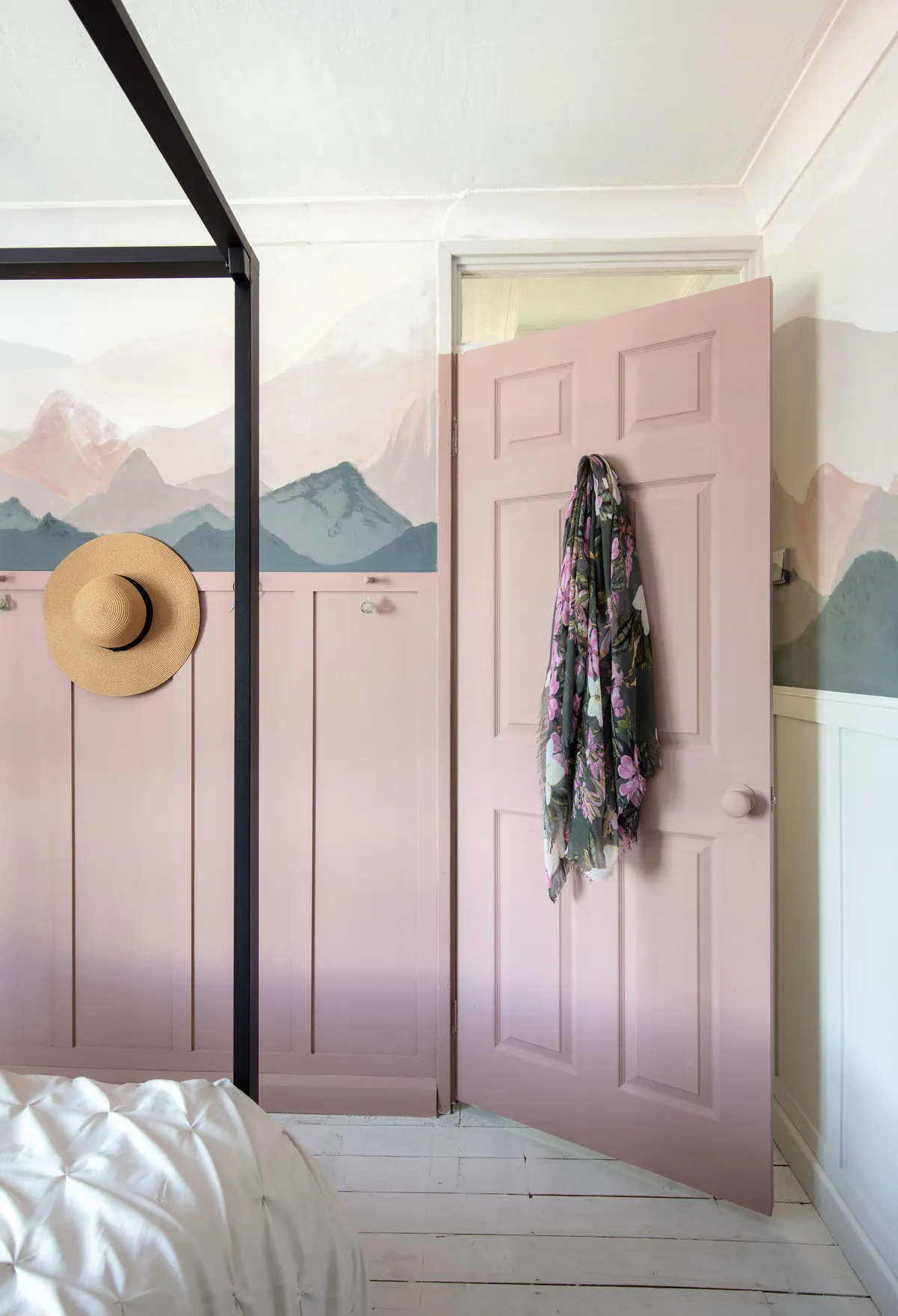 Claire sanded and painted the floorboards white to keep the scheme light. ‘It was a labour of love, but I find doing DIY relaxing,’ she says. She painted the door and frame pink with a white top section to match the mural