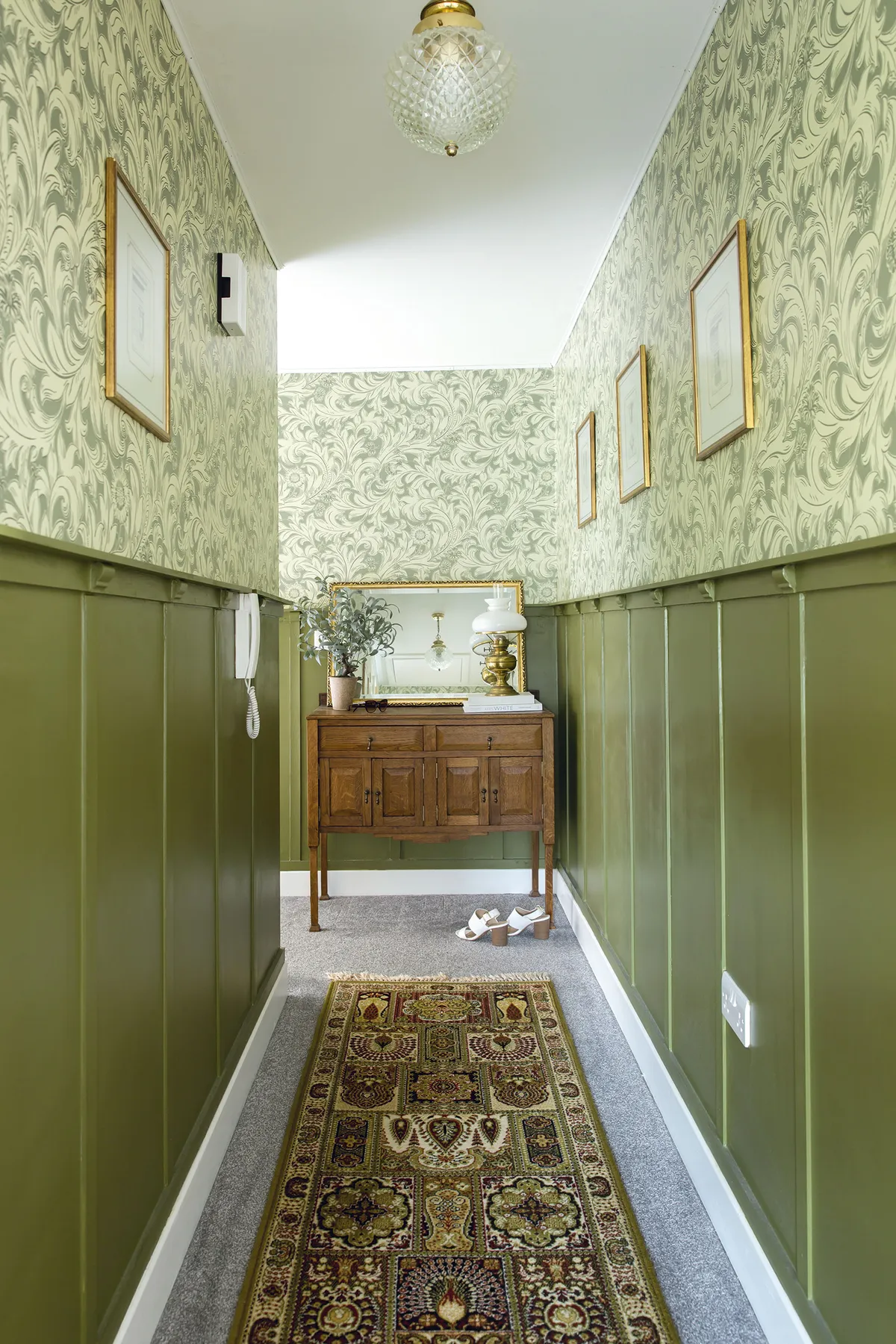 The wallpaper, from Wayfair, sits perfectly above wall panelling painted in Farrow & Ball’s Bancha. The floor runner was a hand-me-down from some family friends, while the lights were just £5 on Facebook Marketplace