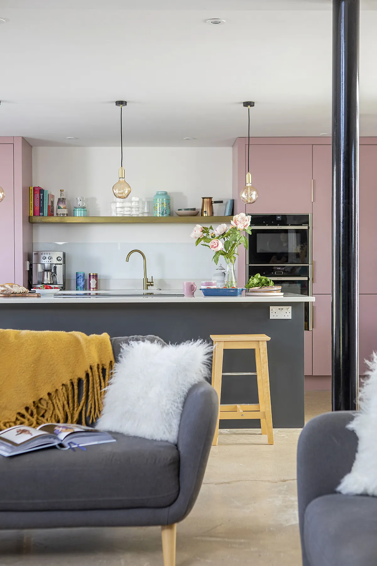 Pink kitchen with grey sofa