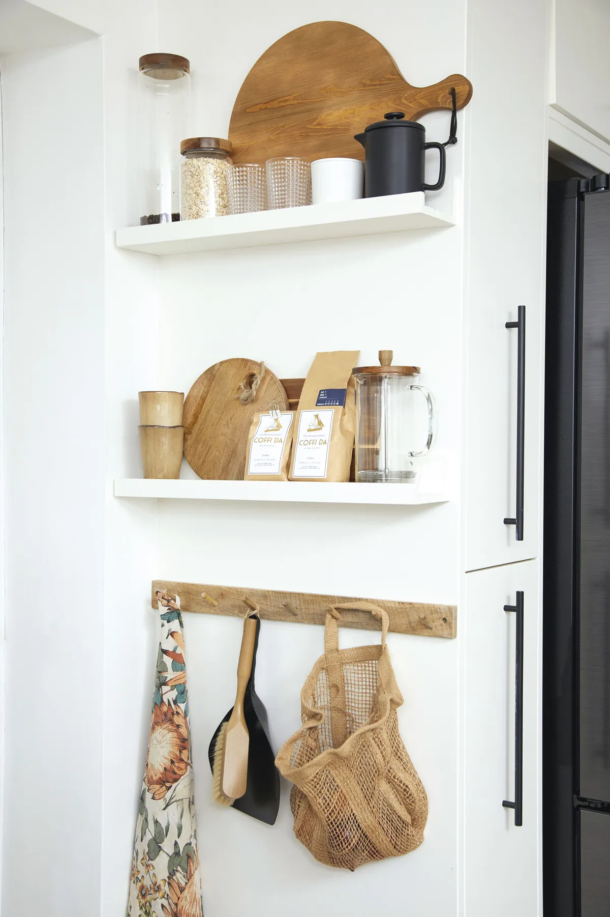 ‘I made this pantry corner out of IKEA picture ledges painted the same colour as the cabinets. I added the wooden hooks, from H&M Home, to create a display and add colour and texture to the space’